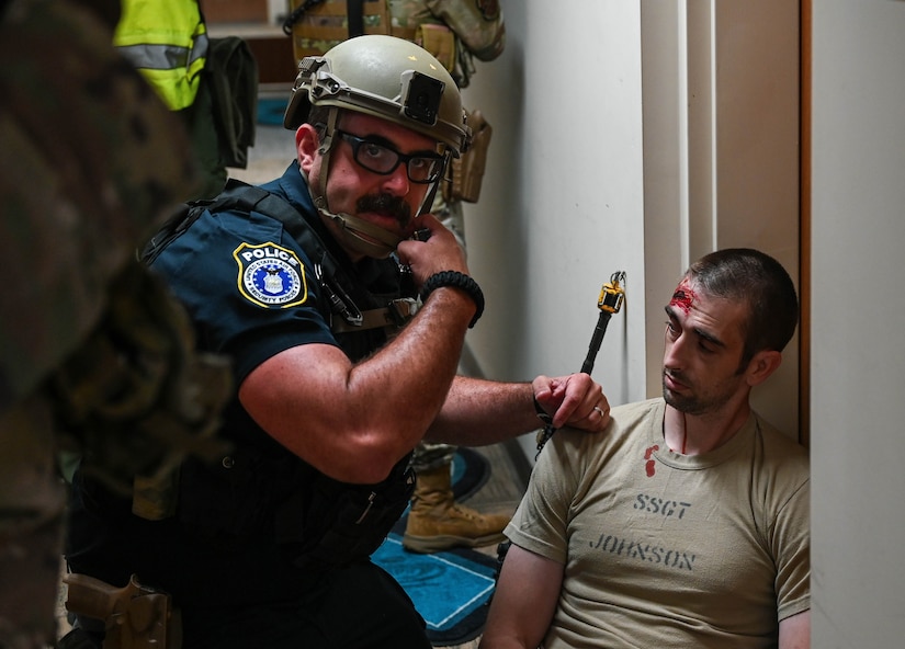 A member of the 633d Security Forces Squadron relays information about simulated causalities during a base-wide active shooter exercise at Joint Base Langley-Eustis, Virginia, June 28, 2022.