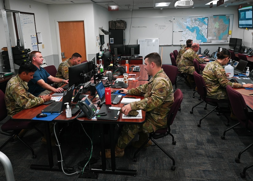 U.S. Air Force Airmen from different organizations on Joint Base Langley-Eustis relay pertinent information back to their work centers from the Emergency Operations Center exercise at JBLE, Virginia, June 28, 2022.