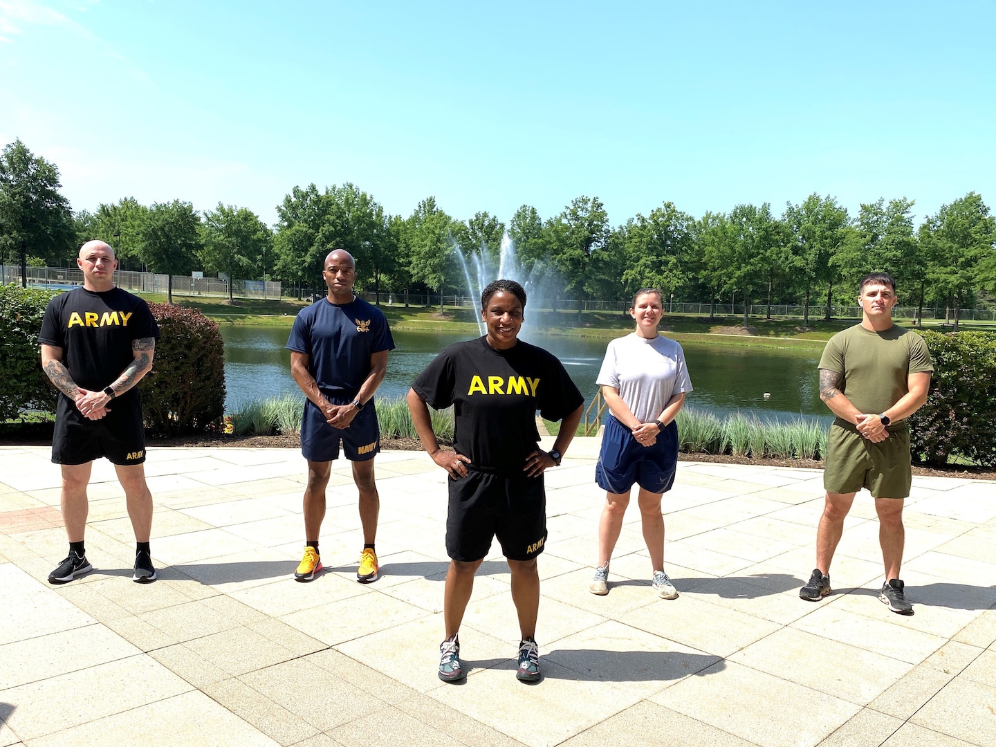 Military service members standing outside by a foundain