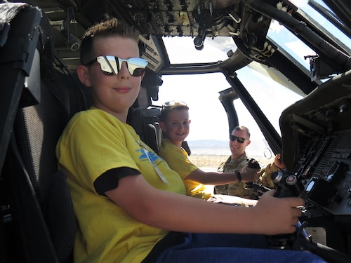 New Mexico Army National Guard pilot Capt. Dustin Offret, lets students get a feel for piloting an Army UH-60 Black Hawk helicopter during the Air Force Research Laboratory's DOD STARBASE STEM Camp at Kirtland Air Force Base, New Mexico, June 14, 2022.
