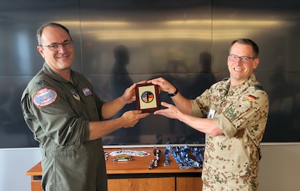 Oberstleutnant Heiko Radermacher, a German Air Force officer, presents 109th Airlift Wing Commander Col. Chris Sander a plaque to commemorate his visit at Stratton Air National Guard Base, Scotia N.Y.  The wing hosted Radermacher in June as part of the Military Reserve Exchange Program.