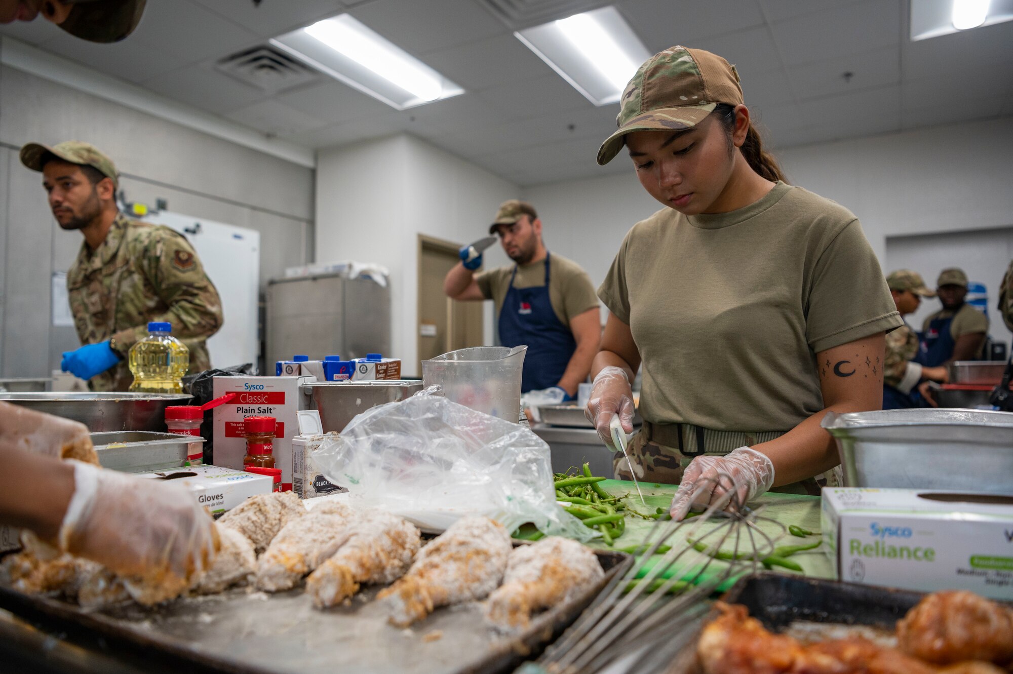U.S. Air Force Chief Master Sgt. Marty Arnold, a 1st Special Operations Force Support Squadron culinary specialist, plates the meal her team has prepared during the 2022 Regional Chef Competition June 30, 2022, at Eglin Air Force Base, Florida.