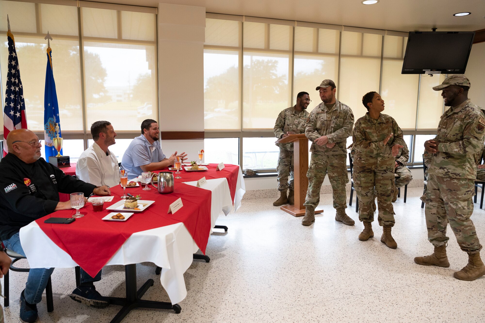 U.S. Air Force Senior Airman Roosevelt Alexander, left, U.S. Air Force Tech. Sgt. Arnold Sandoval, middle, and U.S. Air Force Senior Master Sgt. Ayana Hodges, right, 325th Force Support Squadron culinary specialists, accept their trophy for coming in first place at the 2022 Regional Chef Competition June 30, 2022, at Eglin Air Force Base, Florida.