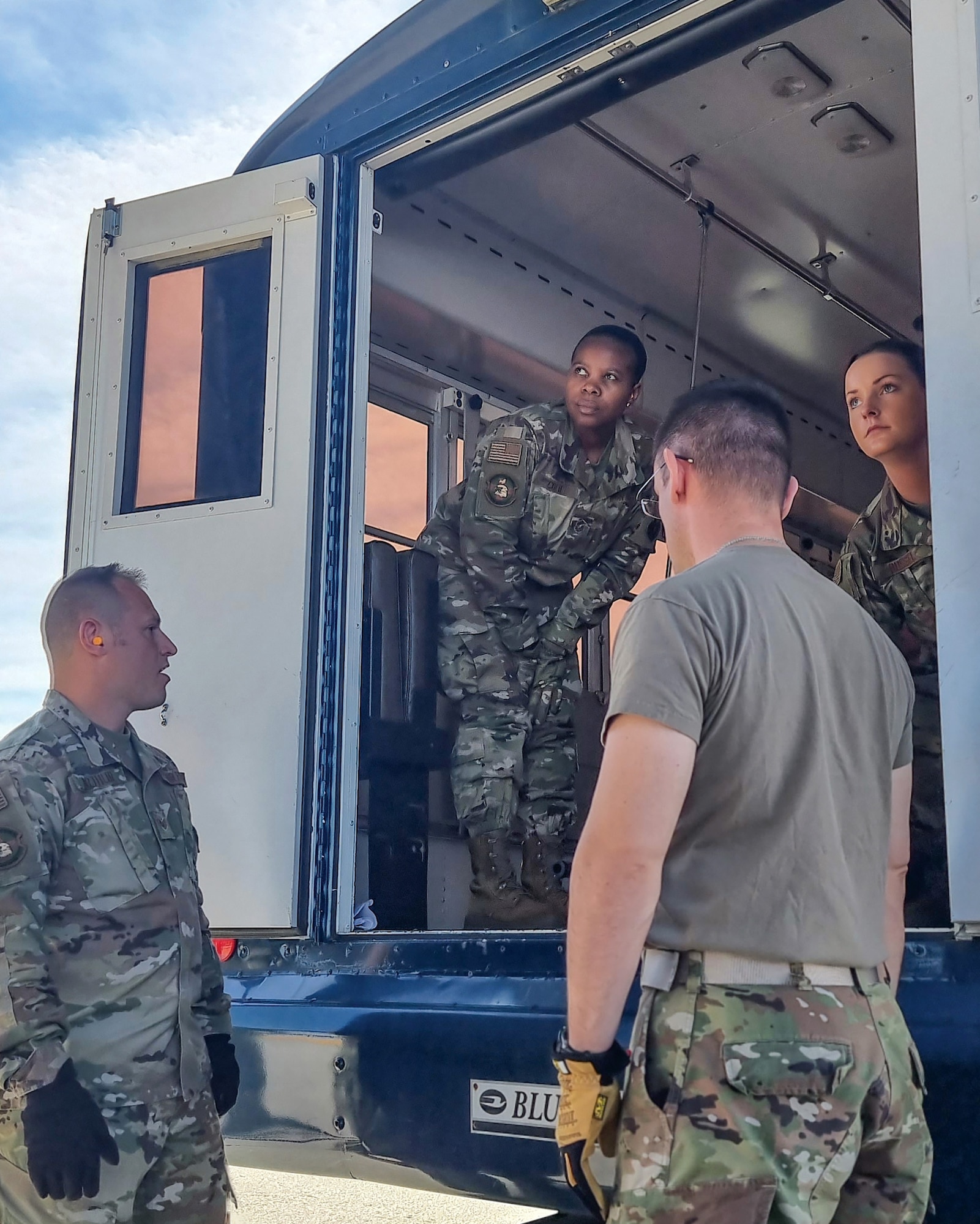 Master Sgt. Litittia Cofie (center), 445th Aeromedical Staging Squadron medical service craftsman and career advisor, and 445th ASTS Airmen, prepare to unload simulated patients during training held at the 445th Airlift Wing June 4, 2022.