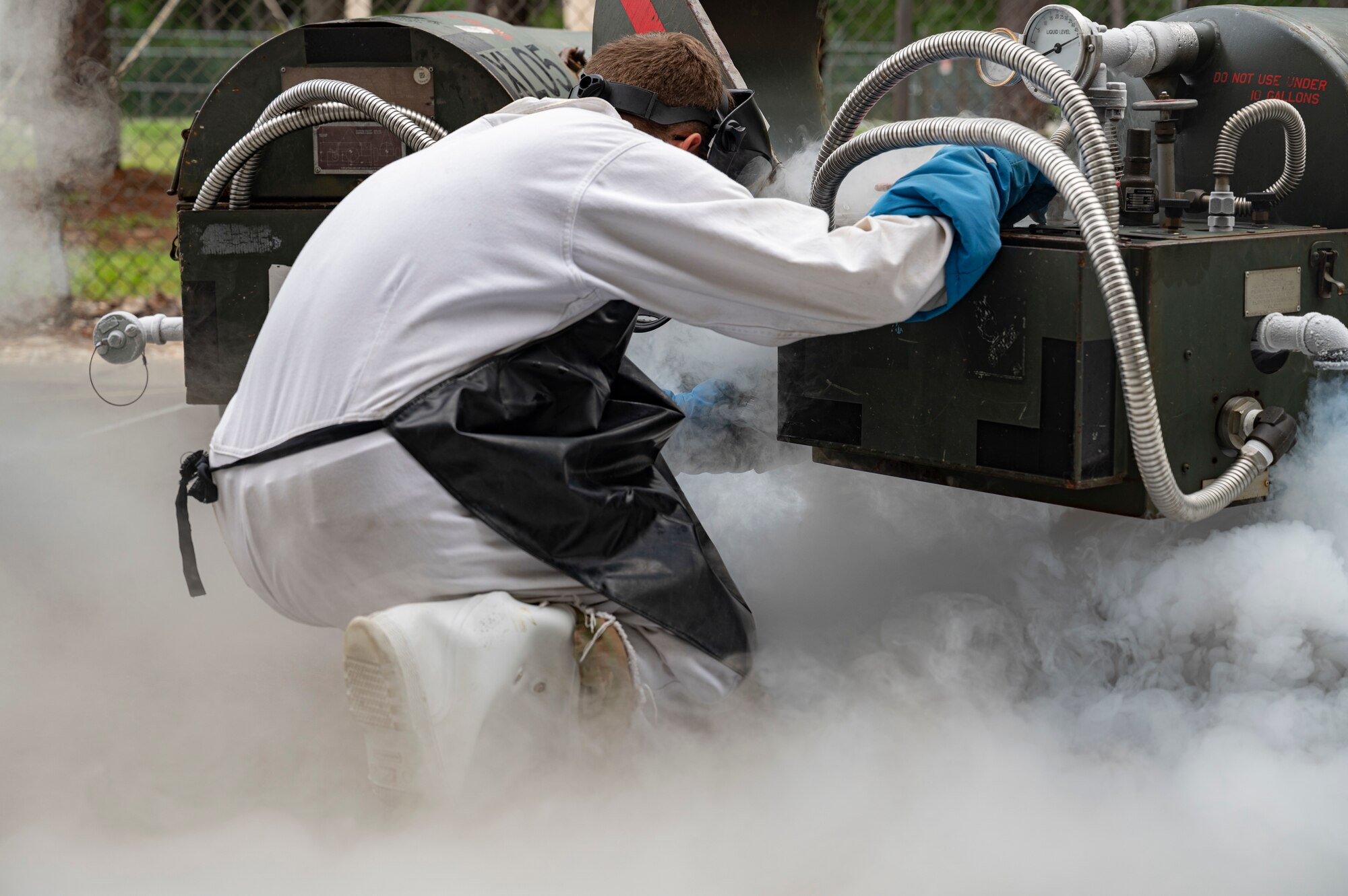 U.S. Air Force Senior Airman Robert Taylor, a 1st Special Operations Logistics Readiness Squadron fuels facilities technician, extracts a liquid oxygen sample from a tank June 15, 2022, at Hurlburt Field, Florida.