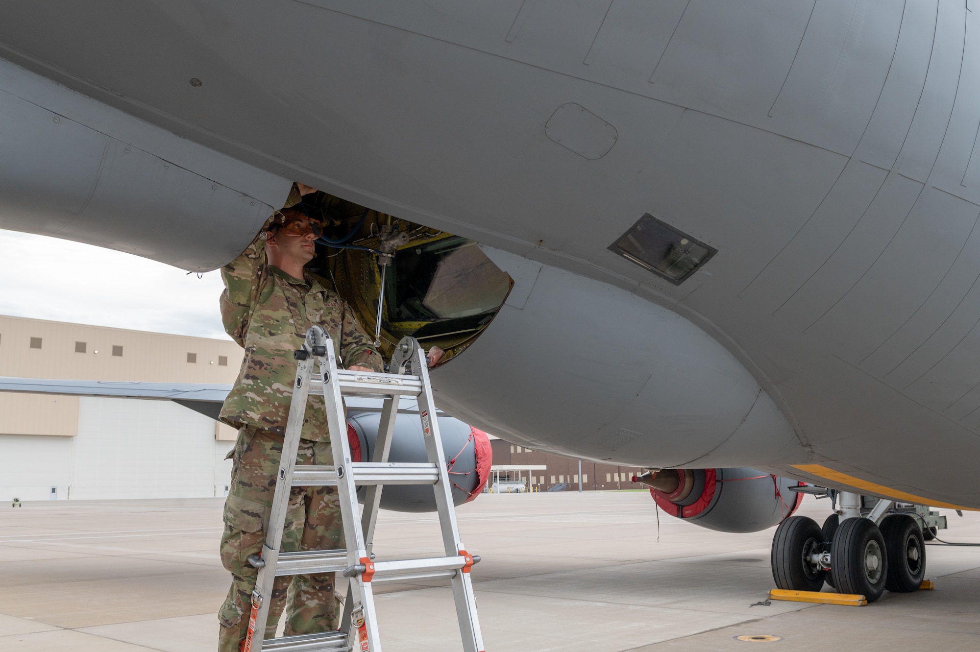 Airman 1st Class Daniel Brody, 22d Aircraft Maintenance Squadron hydraulics apprentice, inspects a KC-135 Stratotanker boom at McConnell Air Force Base, Kansas July 7, 2022. Over the next several years, McConnell plans to transition from the KC-135 to the KC-46 Pegasus as their main refueling aircraft. (U.S. Air Force photo by Airman 1st Class Brenden Beezley)