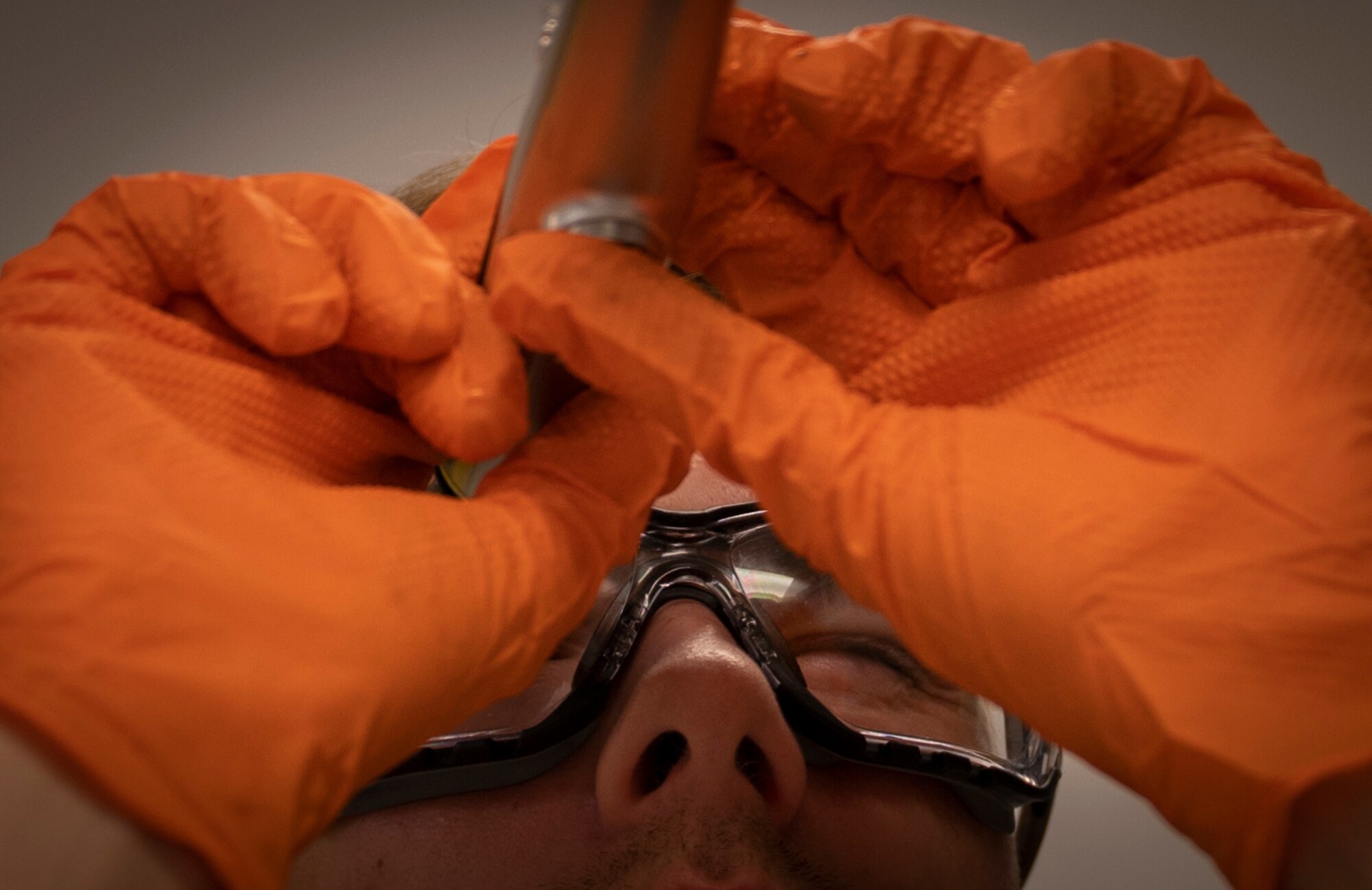U.S. Air Force Senior Airman Donald Hutcheson, a 1st Special Operations Logistics Readiness Squadron fuels laboratory technician, examines a fuel sample and checks for Fuel System Icing Inhibitor contents June 15, 2022, at Hurlburt Field, Florida.