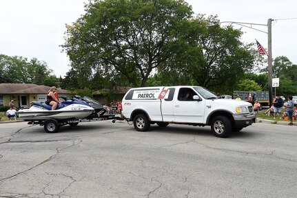 Coast Guard Auxiliary Flotilla 41-02, a Coast Guard support organization from Palatine, Illinois, pulls jet skis during the Rolling Meadows Independence Day parade, July 4, 2022.