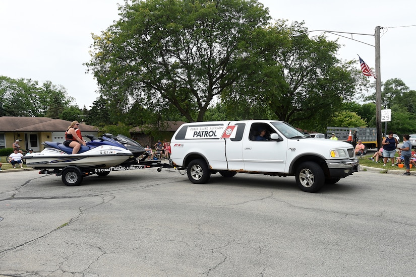 Coast Guard Auxiliary Flotilla 41-02, a Coast Guard support organization from Palatine, Illinois, pulls jet skis during the Rolling Meadows Independence Day parade, July 4, 2022.