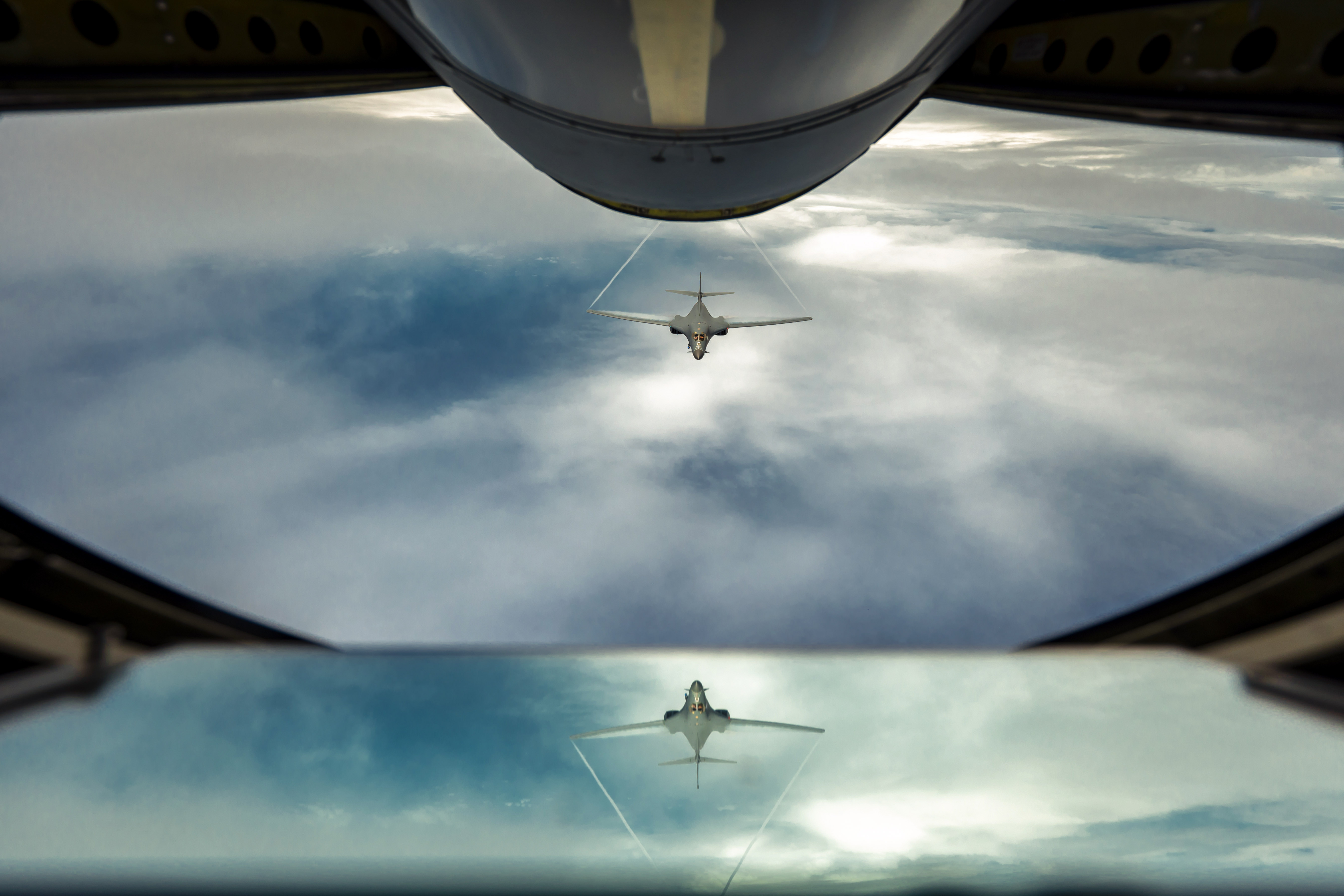 An Air Force B-1B Lancer aircraft flies behind a KC-135 Stratotanker during a bomber task force mission 
