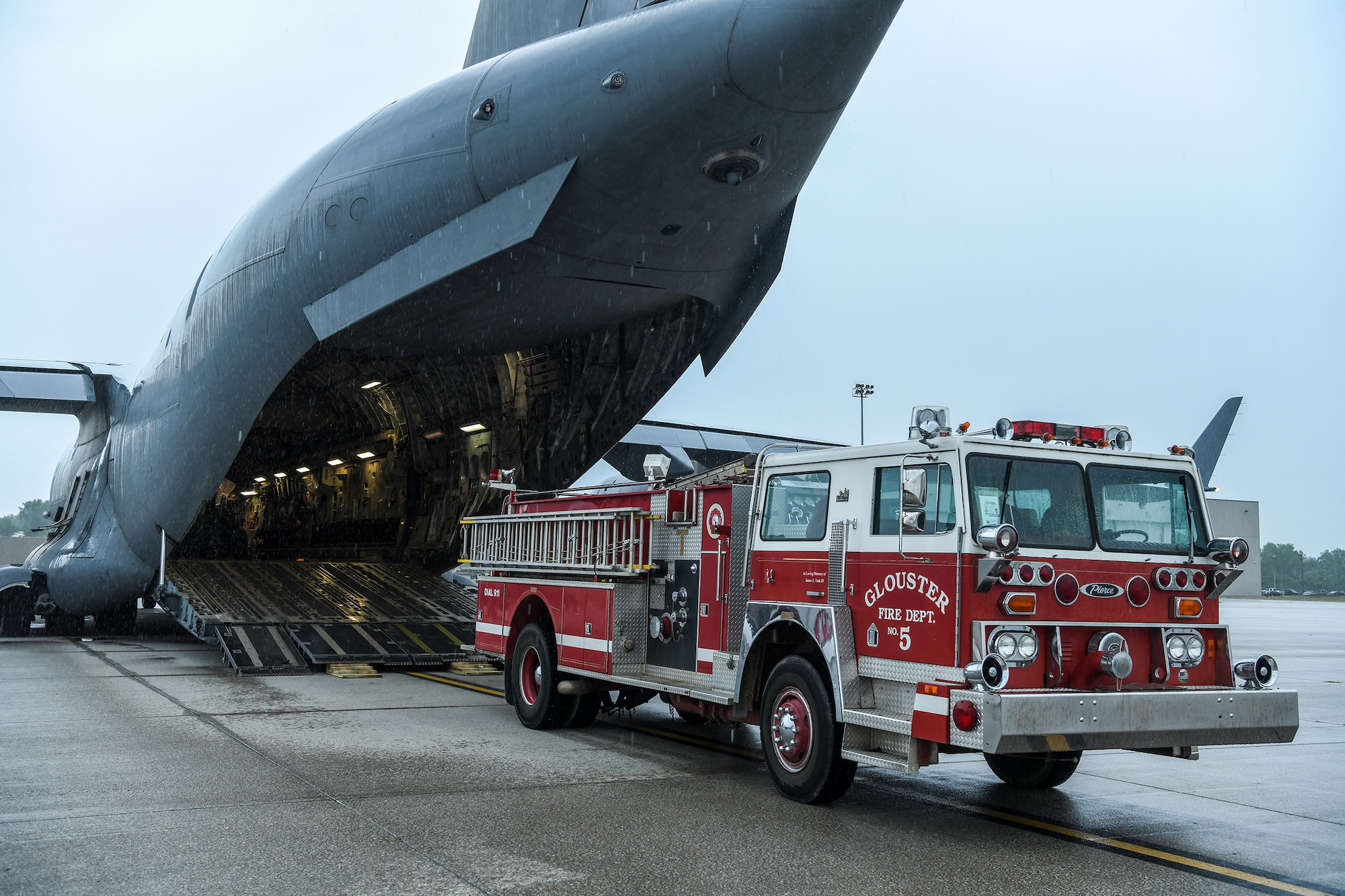 A fire truck is loaded onto a 445th Airlift Wing C-17 Globemaster III July 5, 2022 as part of a Denton Program movement. The C-17 flew to Joint Base Charleston, S.C., the same day and the fire truck has been pre-positioned for its next movement on July 11, 2022 to Belize. James York, III, started the process to have the donated fire truck flown to Belize through the Denton Program but passed away in March of this year soon after his request was approved. His daughters, Holly Monast and Hannah York, wanted to honor his wishes of seeing his plan go thru.