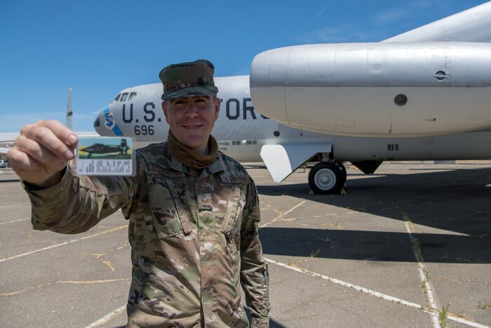 Photo of 2nd Lt. Javier Urzay holding the 35-year-old X-15 rocket-plane playing card that he keeps in his military uniform to this day.