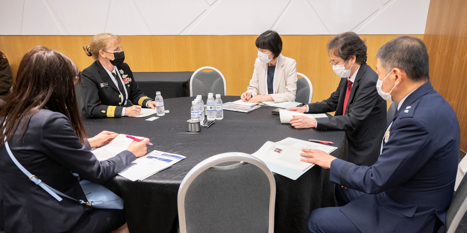 Rear Adm. Pamela Miller (rear-left), Command Surgeon for U.S. Indo-Pacific Command, speaks with delegates from Japan during the second Military-Civilian Health Security Summit June 27, 2022, in Singapore. The summit, held June 27-28, focused on regional approaches to global health security through interagency cooperation with allies and partners.