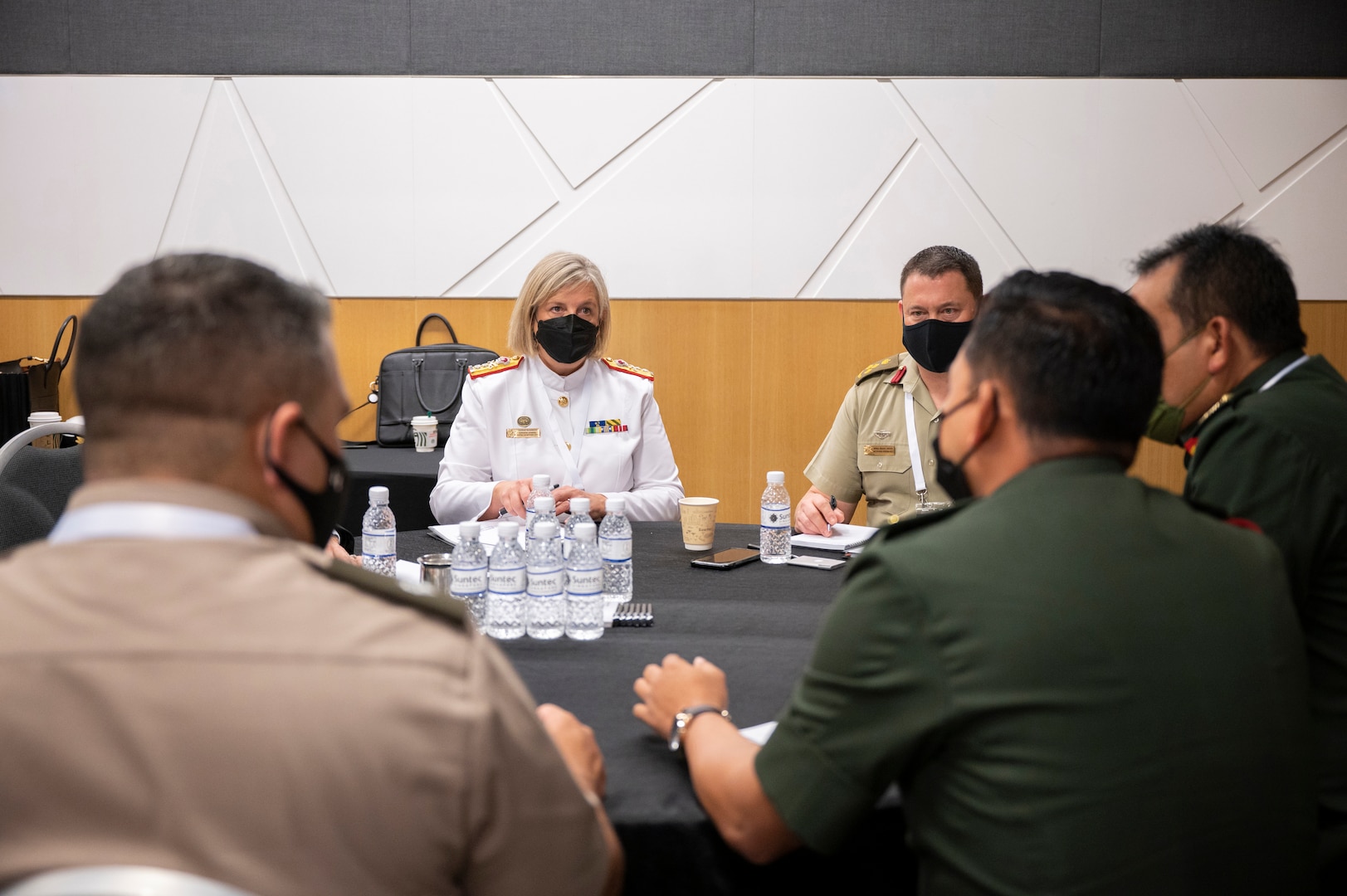 Rear Adm. Sarah Sharkey (left), the Australian Defense Force (ADF) Joint Health Surgeon, speaks with delegates from Malaysia on the treatment of infectious diseases during the second Military-Civilian Health Security Summit June 28, 2022, in Singapore. The summit, held June 27-28, focused on regional approaches to global health security through interagency cooperation with allies and partners.