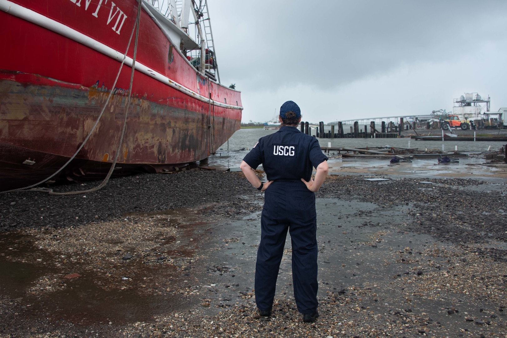 U.S. Coast Guard Chief Petty Officer Joanna Moran, assistant safety officer for the Hurricane Ida Morgan City, Louisiana Incident Command Post, identifies potential safety hazards in Port Fourchon, Louisiana, Sept. 14, 2021. The U.S. Coast Guard is working with interagency partners to identify and clear displaced vessels and hazards to navigation impacting vessel traffic in federal waterways. (U.S. Coast Guard photo by Petty Officer 3rd Class Vincent Moreno)