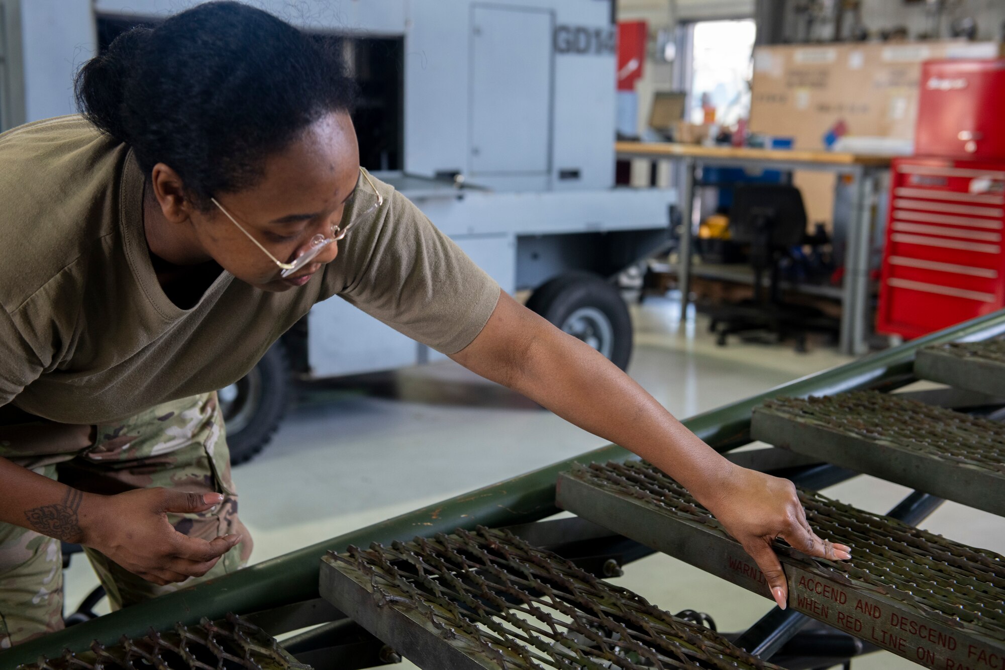 U.S. Air Force Senior Airman Naris Muenrit, 512th Maintenance Squadron aerospace ground equipment technician, adheres a stencil on a B1 aircraft maintenance stand at Dover Air Force Base, Delaware July 6, 2022. Over time, stencils fade and new ones must be re-adhered to provide warnings or directions for use of equipment. In keeping with their squadron’s motto, “Strength in Reserve,” Airmen at the 512th MXS routinely maintain ground equipment to be ready for use with any mission. (U.S. Air Force photo by Senior Airman Ruben Rios)