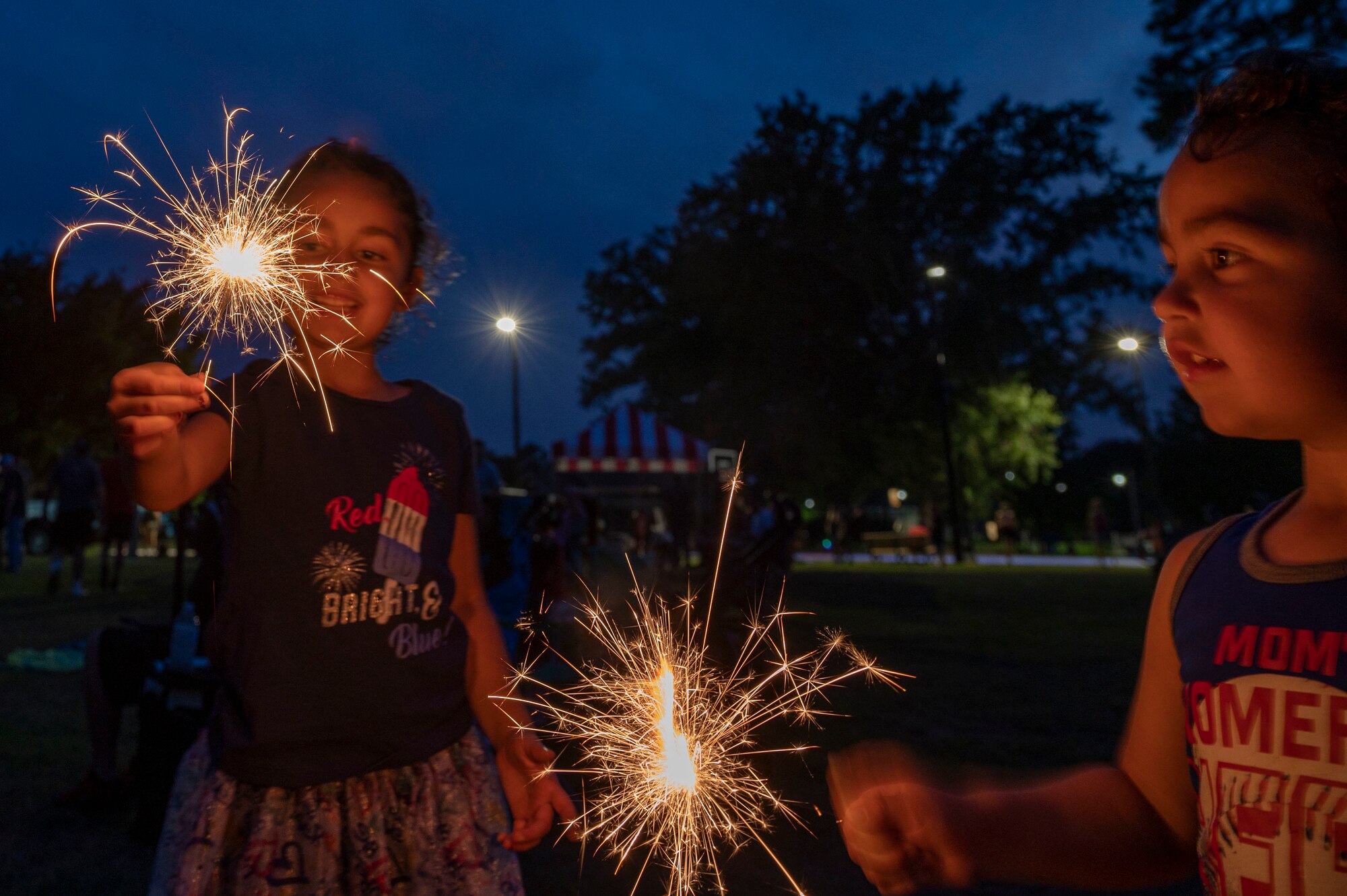 Members of Team Seymour play with sparklers during a 4th of July celebration at Seymour Johnson Air Force Base, North Carolina, June 30, 2022.