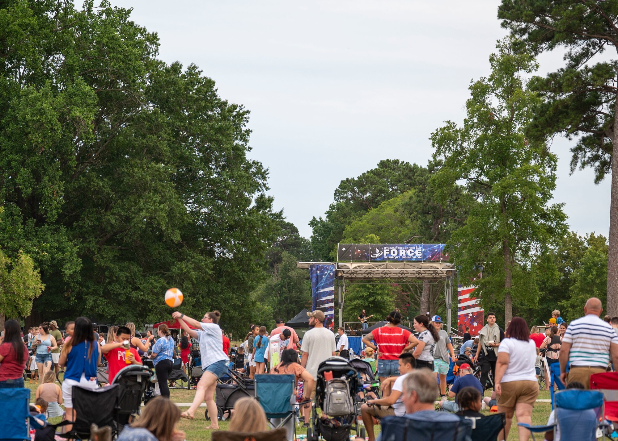 Members of Team Seymour gather and listen to live music during a 4th of July event at Seymour Johnson Air Force Base, North Carolina, June 30, 2022.