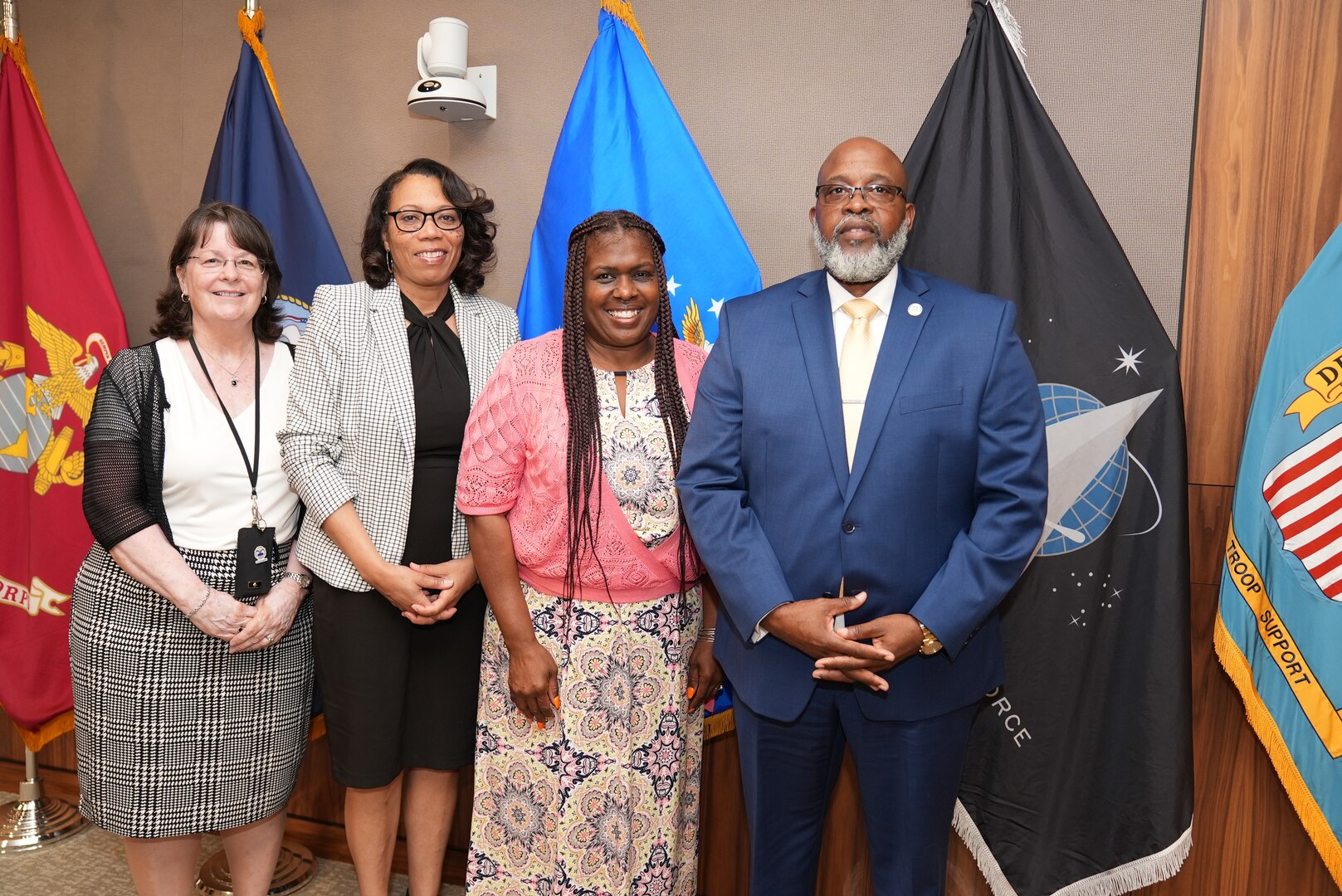 three women and one man civilians smile