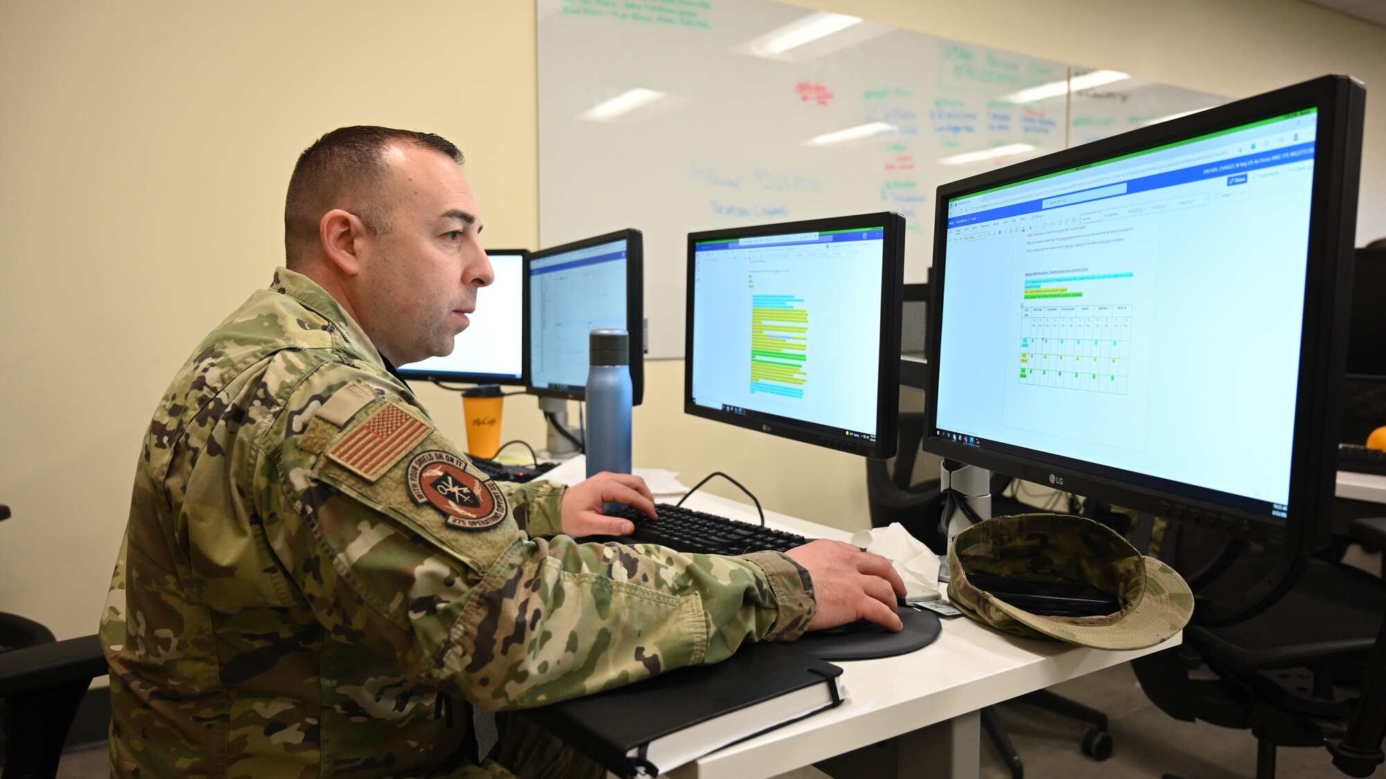U.S. Air Force Maj. Charles Gruver, 275th Operations Support Squadron flight commander, Maryland Air National Guard prepares his workstation before the start of Cyber Blitz 22-3 at Warfield Air National Guard Base, Middle River, Maryland on March 23, 2022.