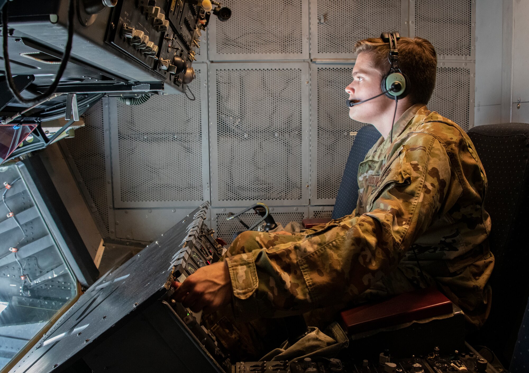 An Airman works in the boom operator station of a KC-10 Extender.