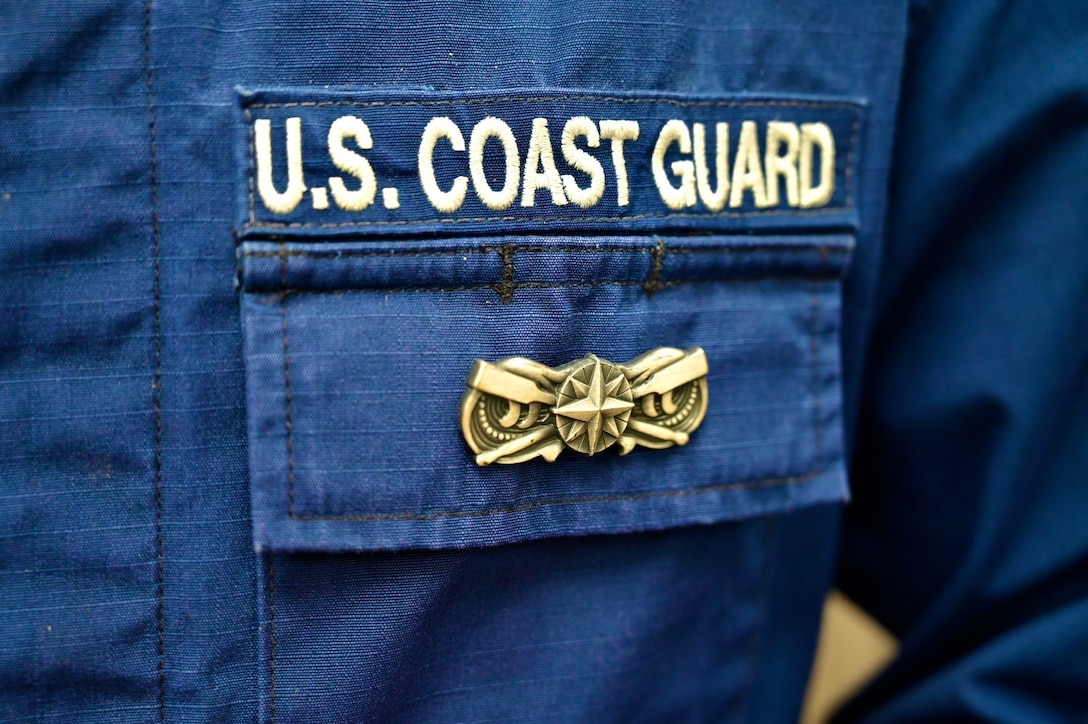 A Coast Guard Station Ketchikan boat crew member displays the pewter-tone boat force operations insignia on an operational dress uniform, Ketchikan, Alaska, Feb. 6, 2020.