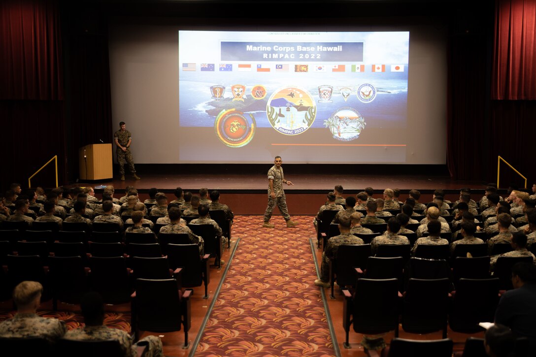 Service members take part in an orientation brief prior to Rim of the Pacific 2022, Marine Corps Base Hawaii, June 29-30, 2022. The brief was conducted in order to familiarize RIMPAC participants on MCBH facilities and training area regulations, while also providing awareness of cultural and natural resources. (U.S. Marine Corps photo by Cpl. Brandon Aultman)