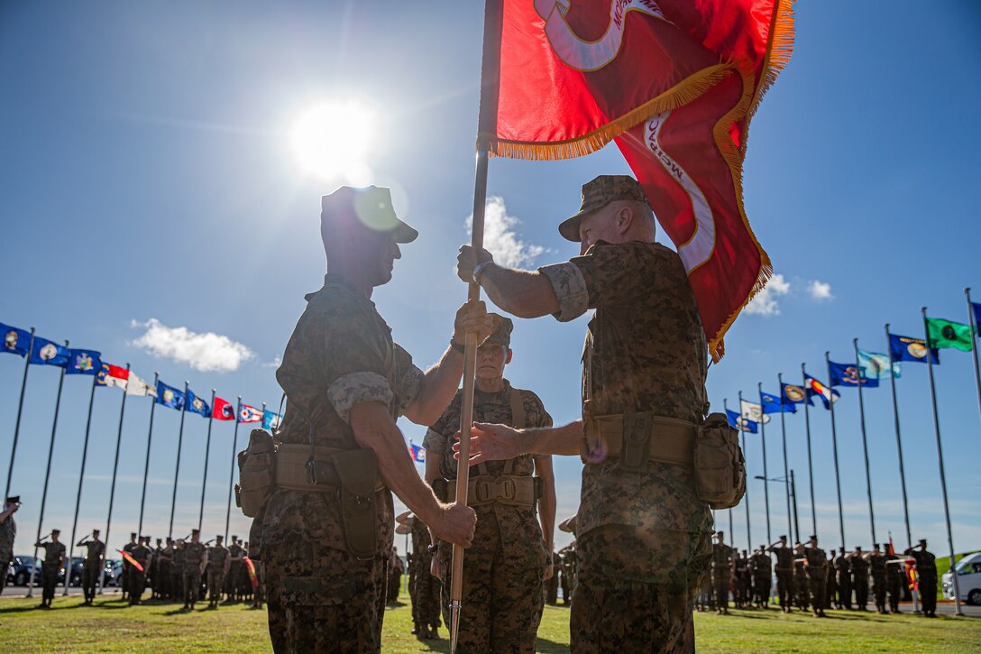 U.S. Marine Corps Maj. Gen. Stephen E. Liszewski, left, incoming commanding general, MarineCorps Installations Pacific, Marine Corps Base Camp Butler, receives the unit’s guidon during a change of command ceremony from Maj. Gen. William J. Bowers, right, outgoing commanding general, MCIPAC, MCBB, outside of MCIPAC’s Headquarters Building, Camp Foster, Okinawa, Japan, on June 24, 2022. Change of command ceremonies allow individuals to witness the official passing of authority change between officers. During the ceremony, the outgoing commander passes the unit’s guidon to the incoming commander, symbolizing the transfer of authority, responsibility, and total commitment to all Marines and Sailors. (U.S. Marine Corps photo by Cpl. Alex Fairchild)