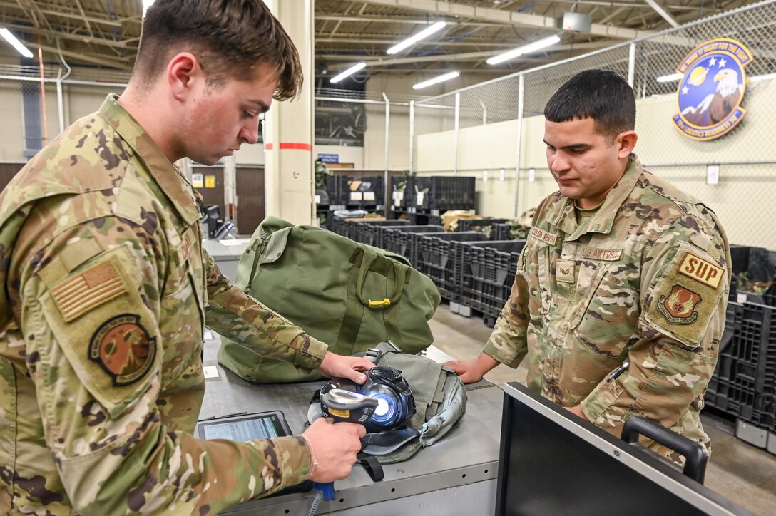 Airman 1st Class Jacob Chatigny, 75th Logistics Readiness Squadron, scans a gas mask for Senior Airman Hector Colon Ventura, 75th LRS, June 15, 2022, at Hill Air Force Base, Utah.