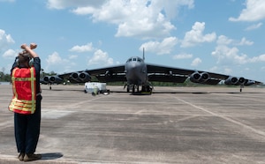 Senior Airman William Colbert, a 20th Aircraft Maintenance Unit crew chief, marshals a B-52H Stratofortress on the flight line at the Chennault International Airport during an Agile Combat Employment readiness exercise June 24, 2022 in Lake Charles, Louisiana. The B-52H Stratofortress is a long-range, nuclear and conventional heavy bomber that can perform a variety of missions. (U.S. Air Force photo by Tech. Sgt Delia Martinez)