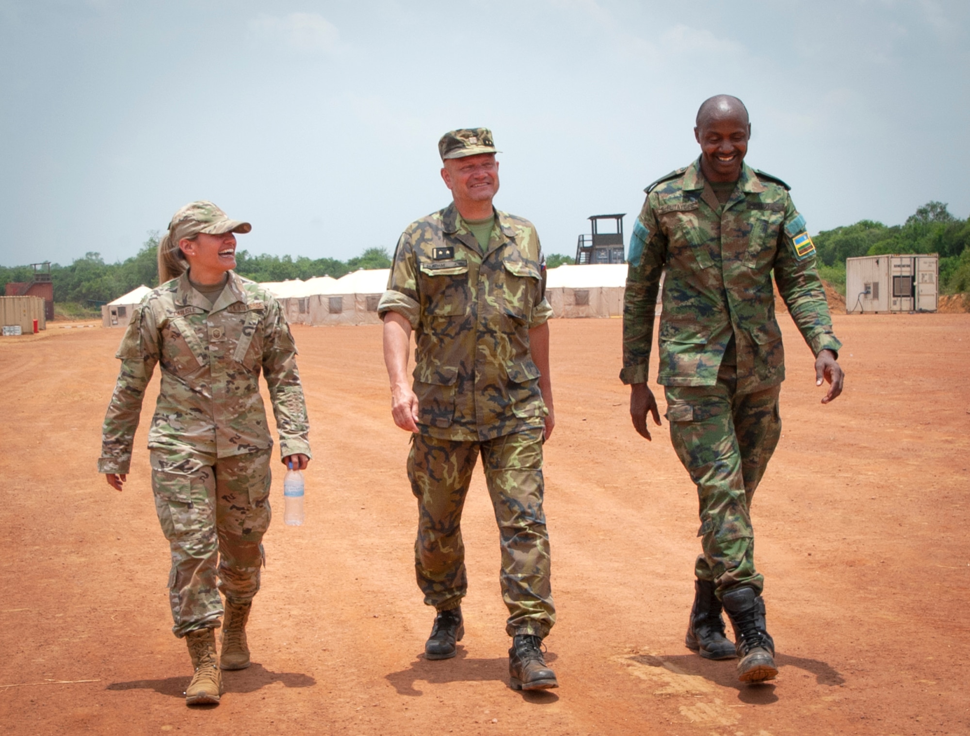 From left, Nebraska Air National Guard Maj. Angela Ling, Lt. Col. Adam Miroslav of the Czech Republic, and Rwandan Defense Force Maj. B. Rutayisire chat while walking across the hospital training site at Gako, Rwanda, March 16, 2022. The three were participating in a medical/engineering exchange exercise conducted in concert with the new State Partnership Program relationship between the Nebraska National Guard and the Rwandan Defense Force.