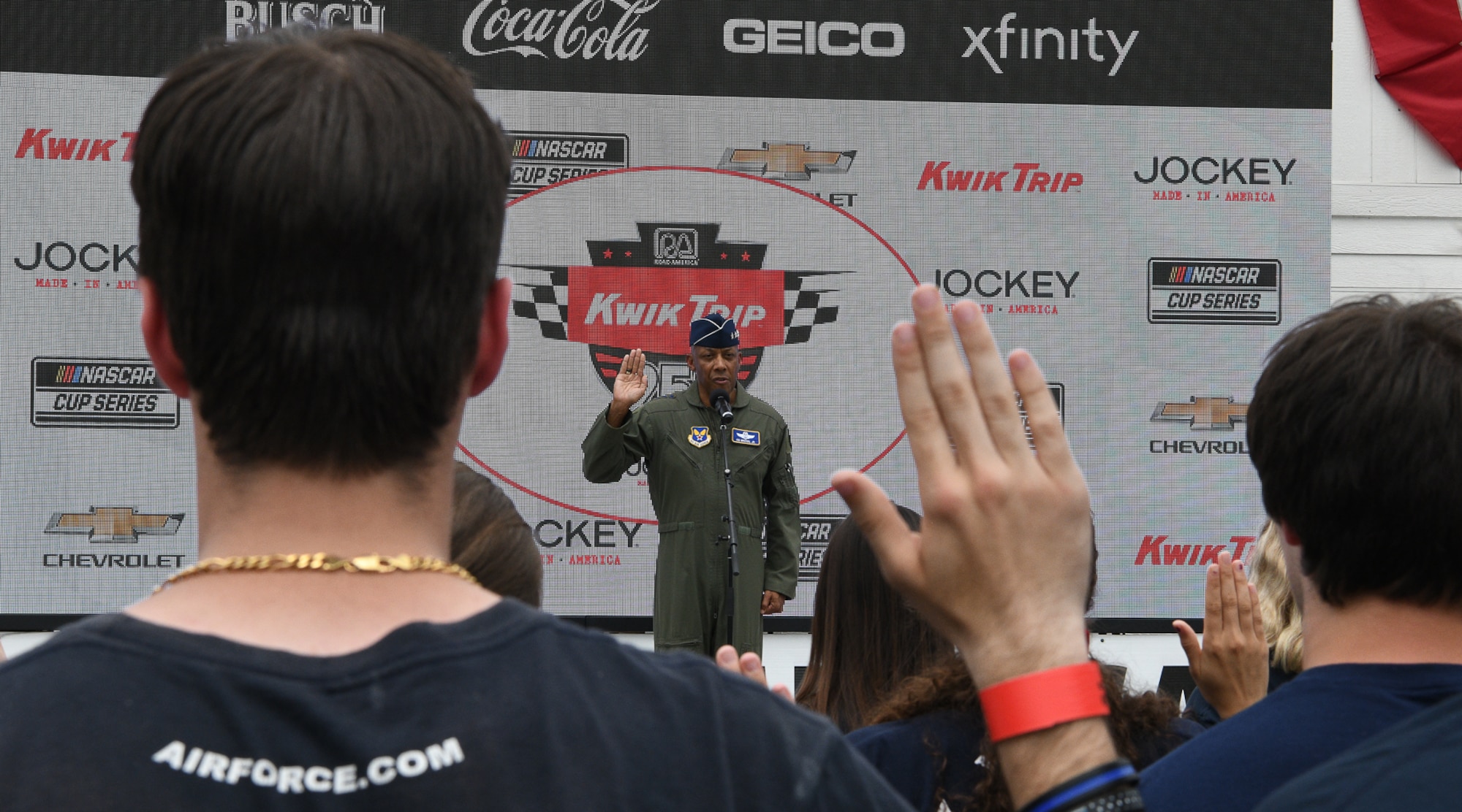 Air Force Chief of Staff Gen. CQ Brown, Jr. administers the Oath of Enlistment for 23 future Airmen, at Victory Lane inside the Road America race course, near Elkhart Lake, Wisconsin, July 3, 2022.