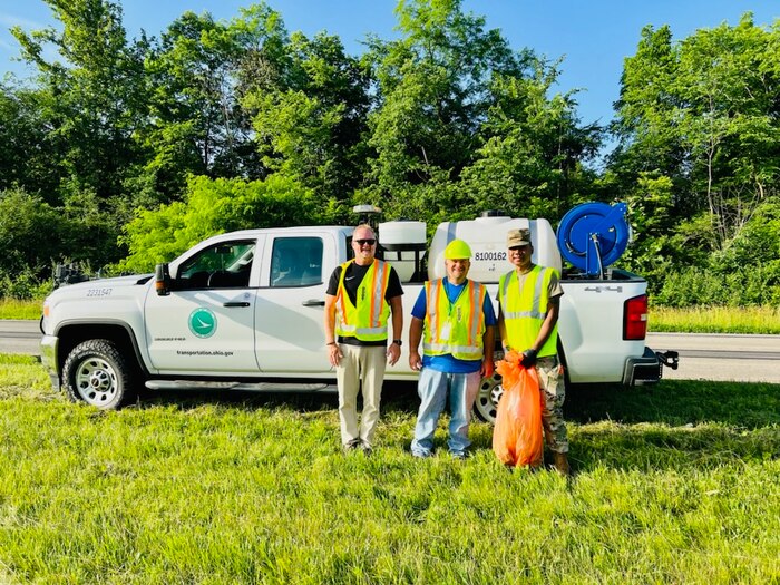 Personnel pick up litter along local roads