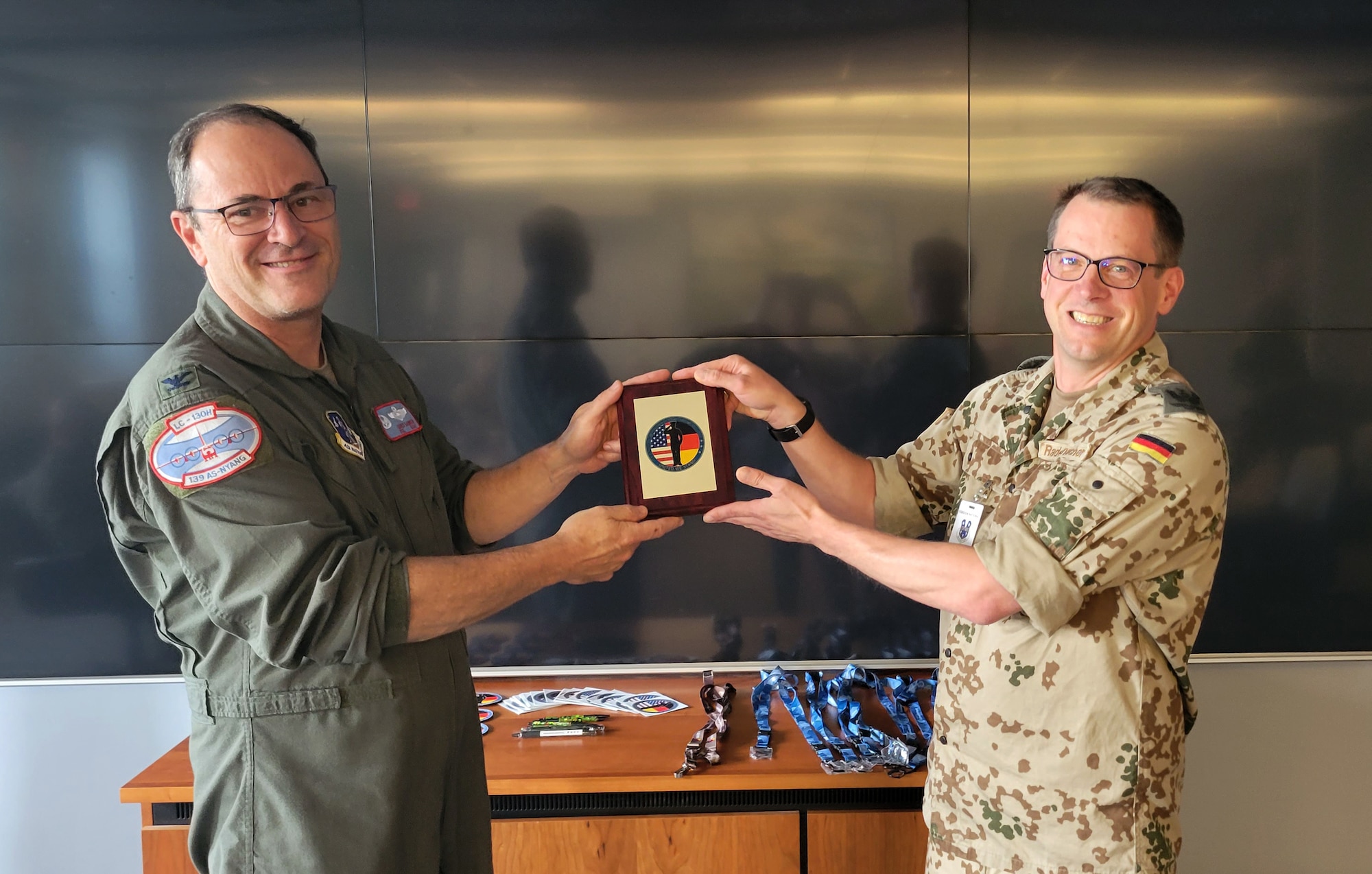 Oberstleutnant Heiko Radermacher, a German Air Force officer, presents 109th Airlift Wing Commander Col. Chris Sander a plaque to commemorate his visit at Stratton Air National Guard Base, Scotia N.Y.  The wing hosted Radermacher in June as part of the Military Reserve Exchange Program.