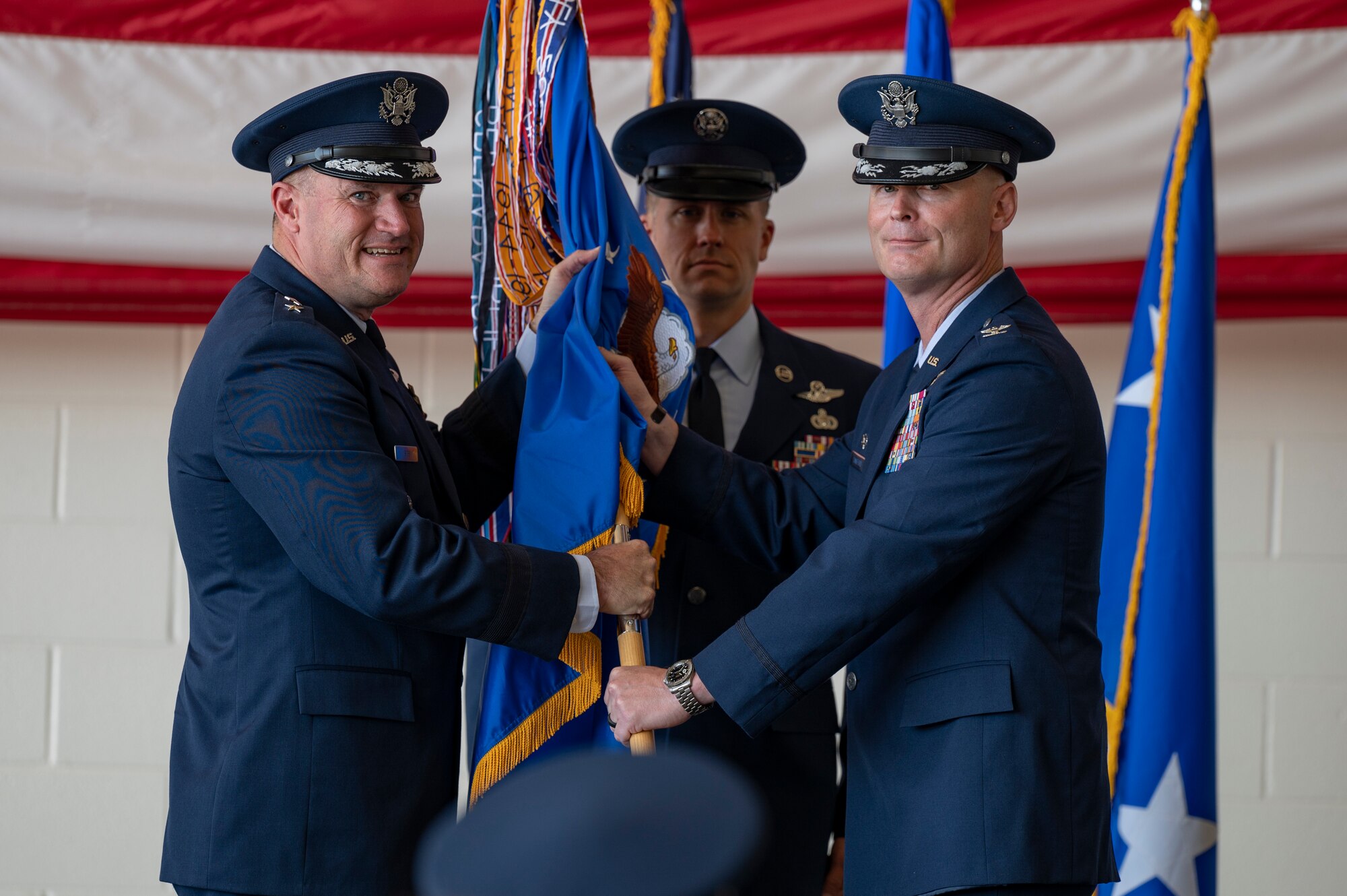 Maj. Gen. Kenneth Bibb, 18th Air Force commander, gives the guidon to Col. Thomas Lankford, inbound 317th Airlift Wing commander, at Dyess Air Force Base, Texas, July 7, 2022. As Commander, Lankford will lead Mobility Air Force operations on the installation for C-130J Super Hercules tactical airlift, and is responsible for organizing, training, and equipping 1,200 combat-ready personnel who operate, maintain, and sustain 28 aircraft. (U.S. Air Force photo by Senior Airman Josiah Brown)