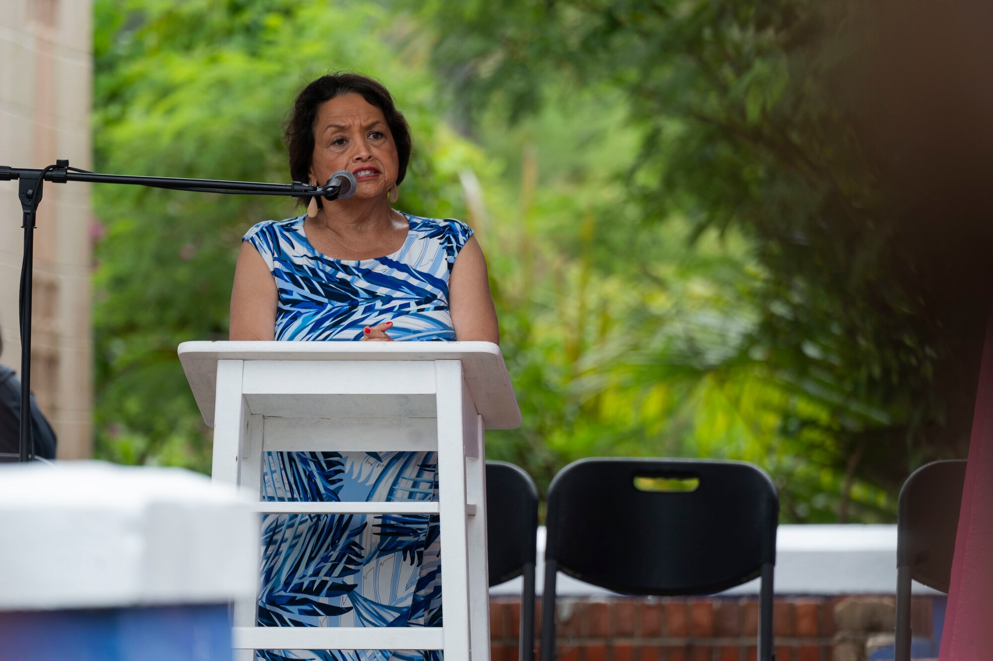 A woman speaking during a ceremony.