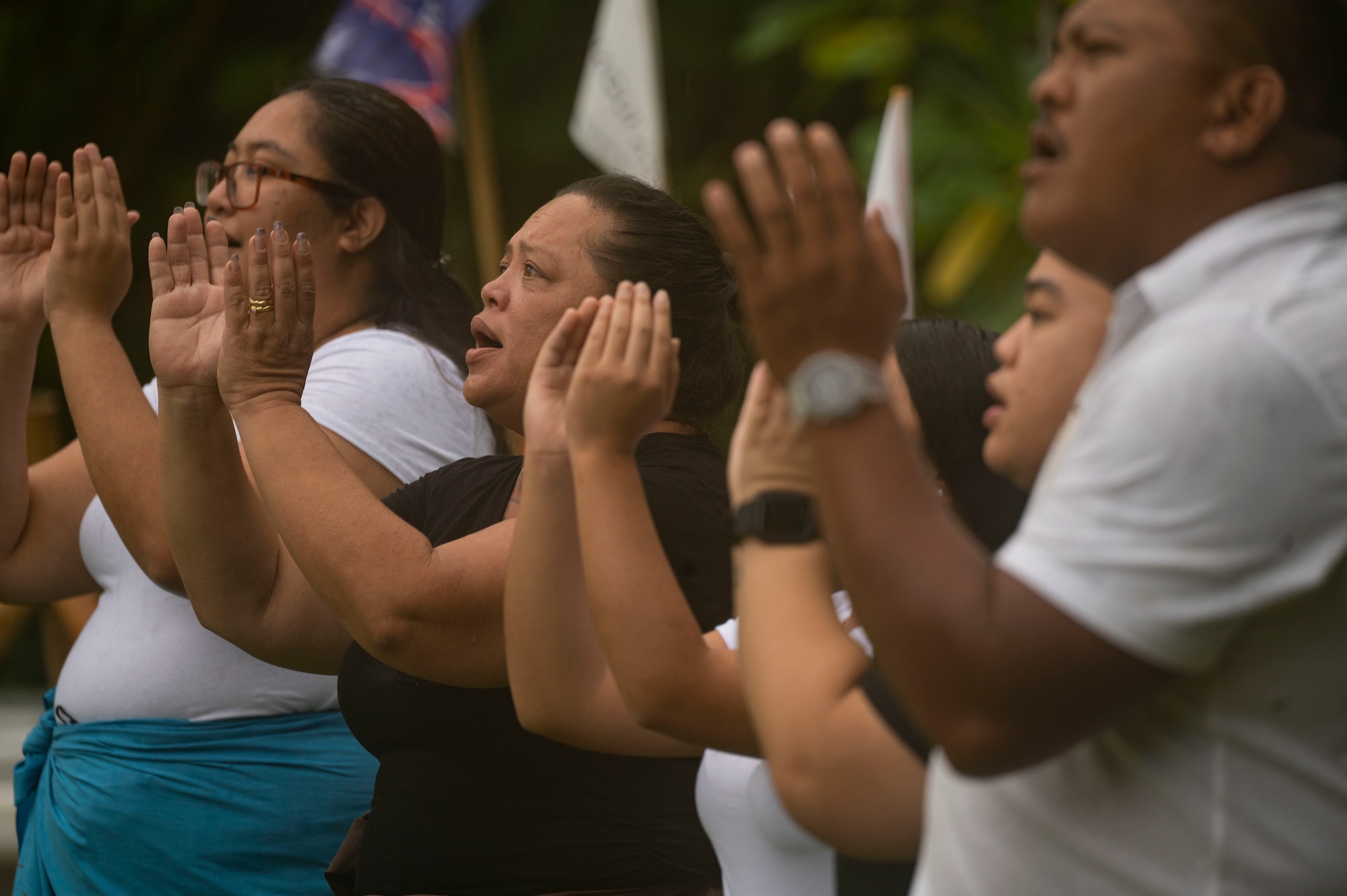 A group of people perform a cultural blessing.