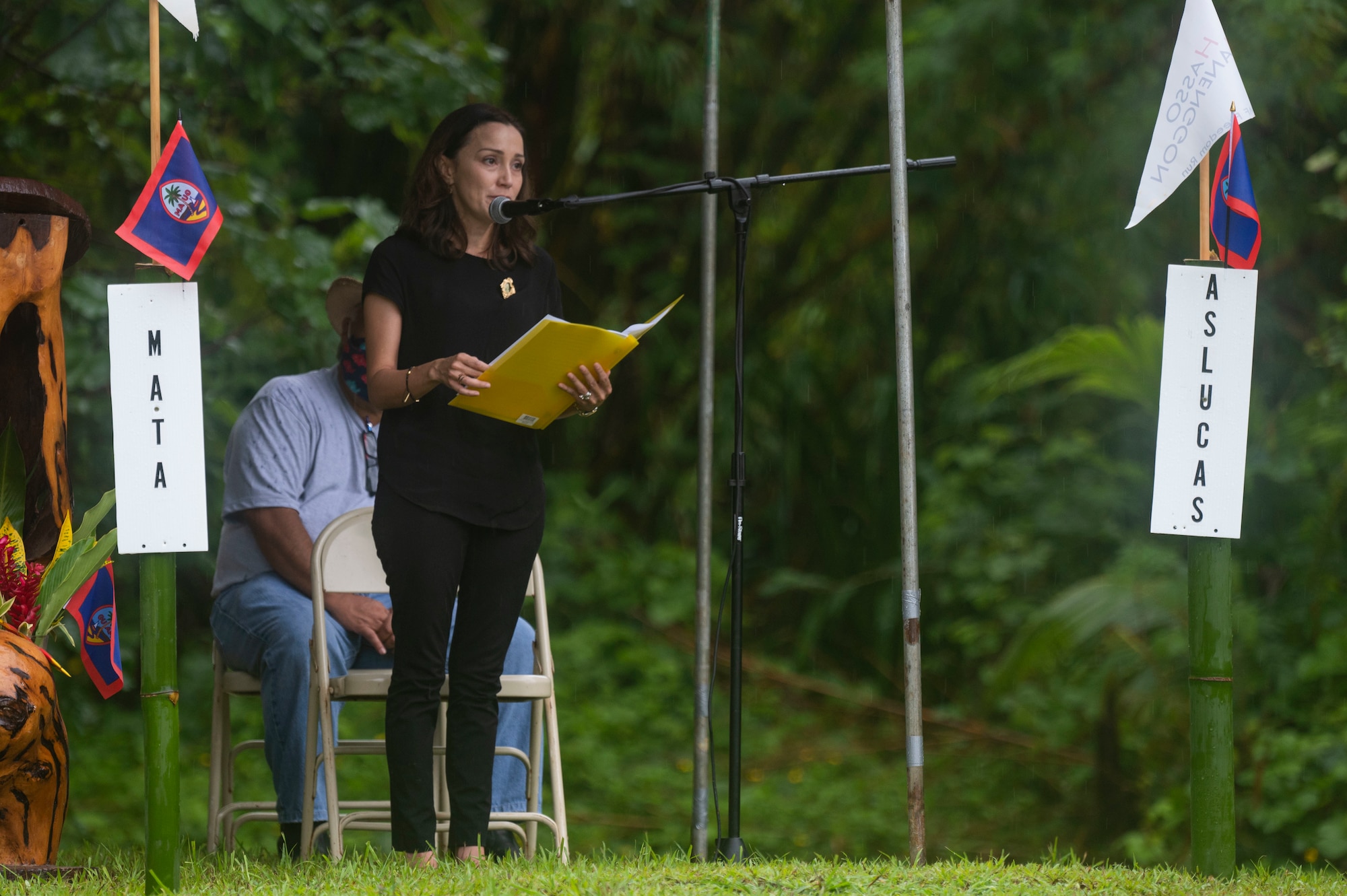 A woman speaking at a ceremony.