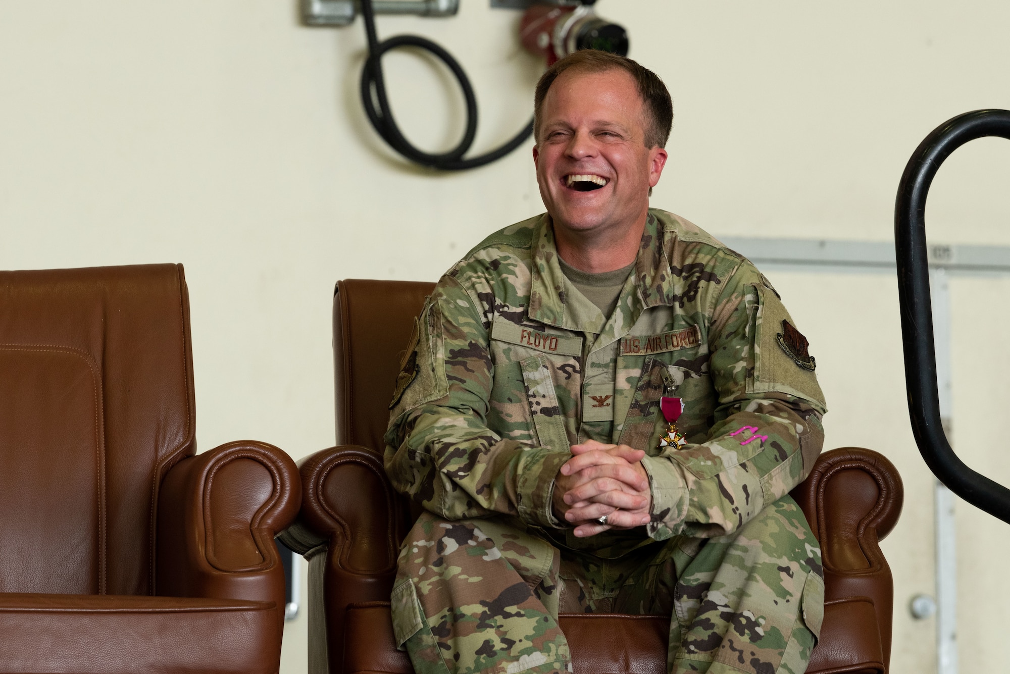 Col. Garry Floyd, 694th Intelligence, Surveillance and Reconnaissance Group commander, laughs at closing remarks during a change of command at Osan Air Base, Republic of Korea, 8 July, 2022.