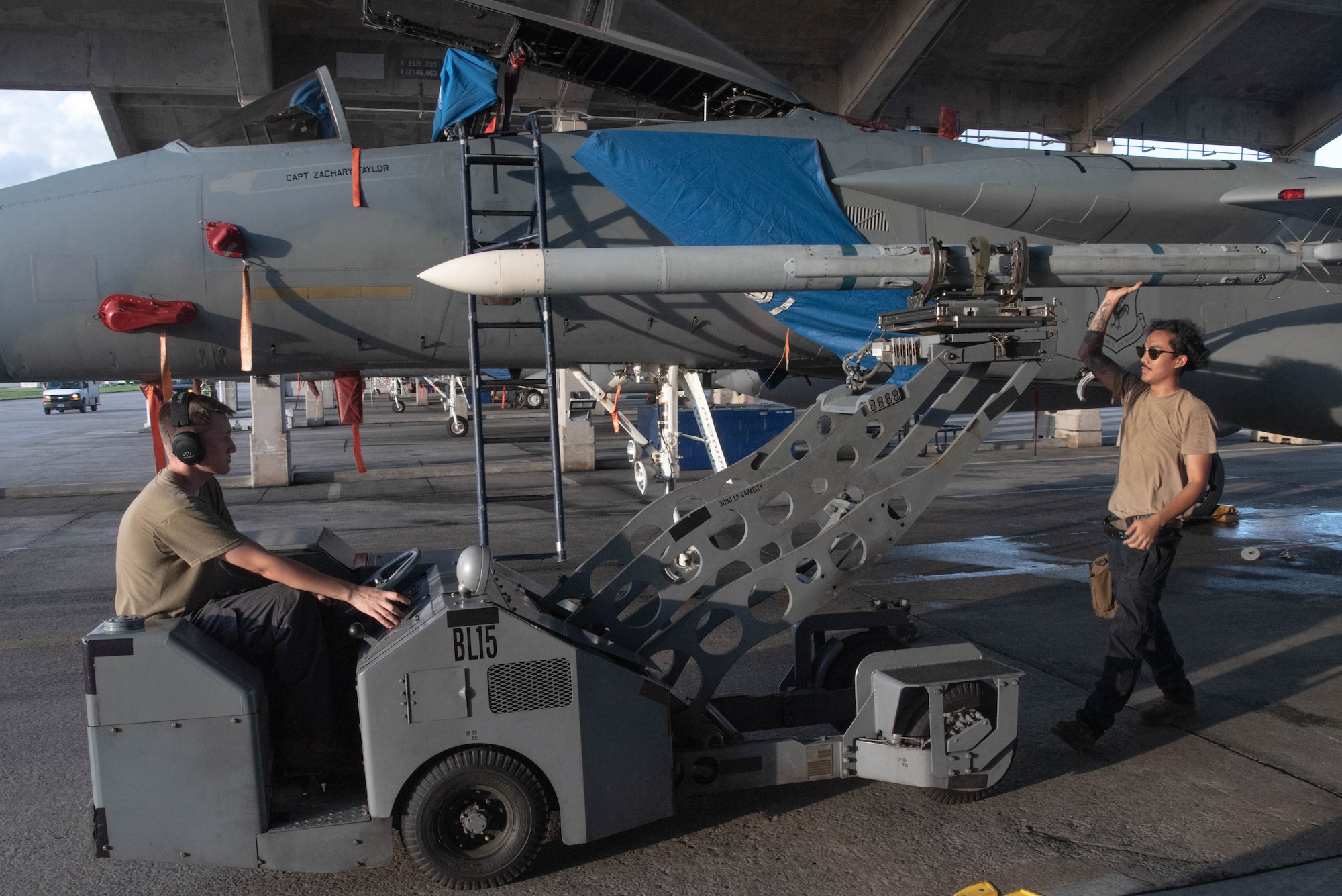 Airmen from the 44th AMU operate machinery and remove munitions from a F-15C