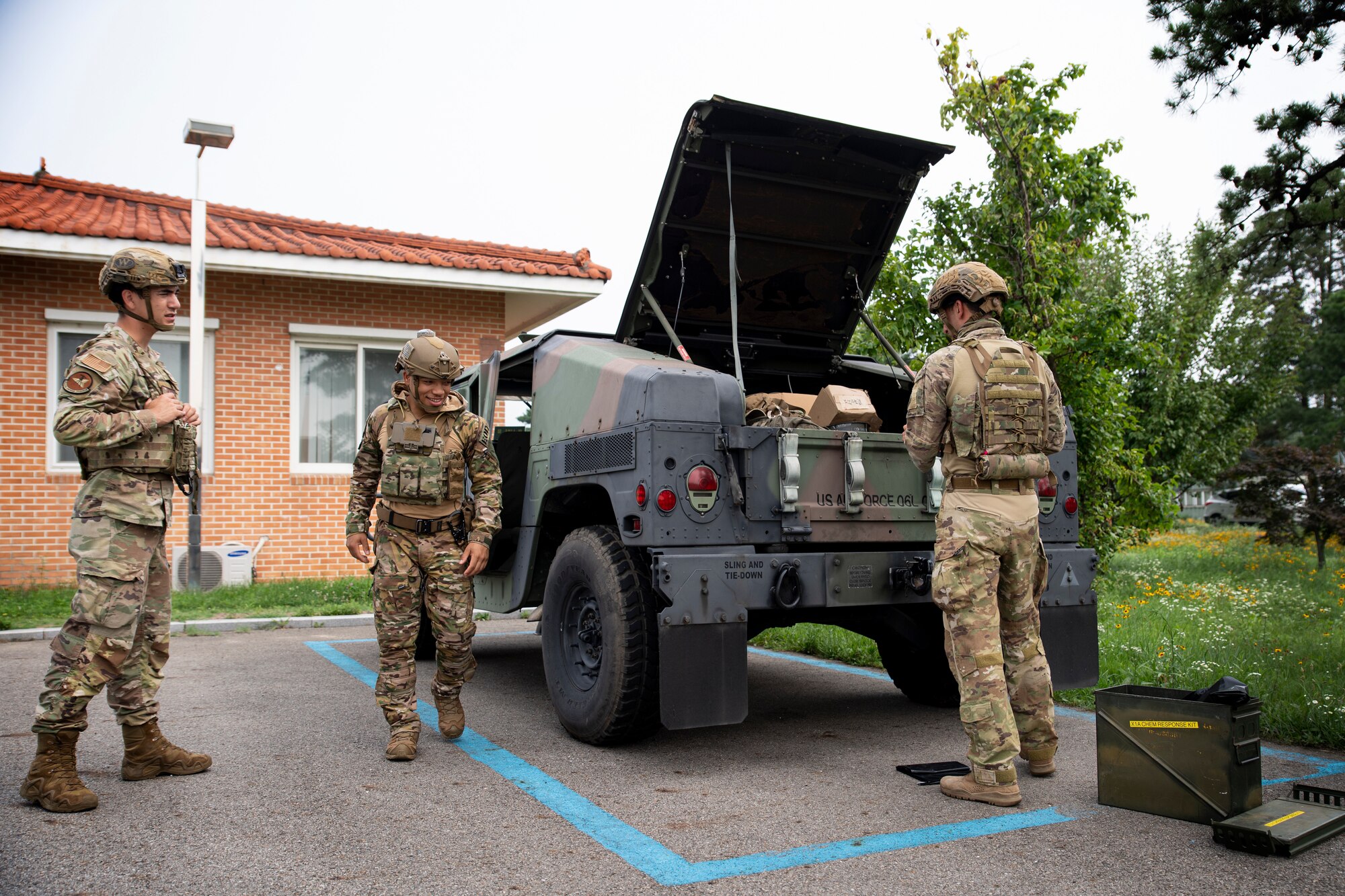 U.S. Air Force Senior Airmen Omar Navarro and Joshua Young, along with Staff Sgt. Michael Augustus, 35th Civil Engineer Squadron, Explosive Ordnance Disposal technicians from Misawa Air Base, Japan, prepare to respond to a mock chemical weapon scenario at Suwon Air Base, Republic of Korea, July 6, 2022.