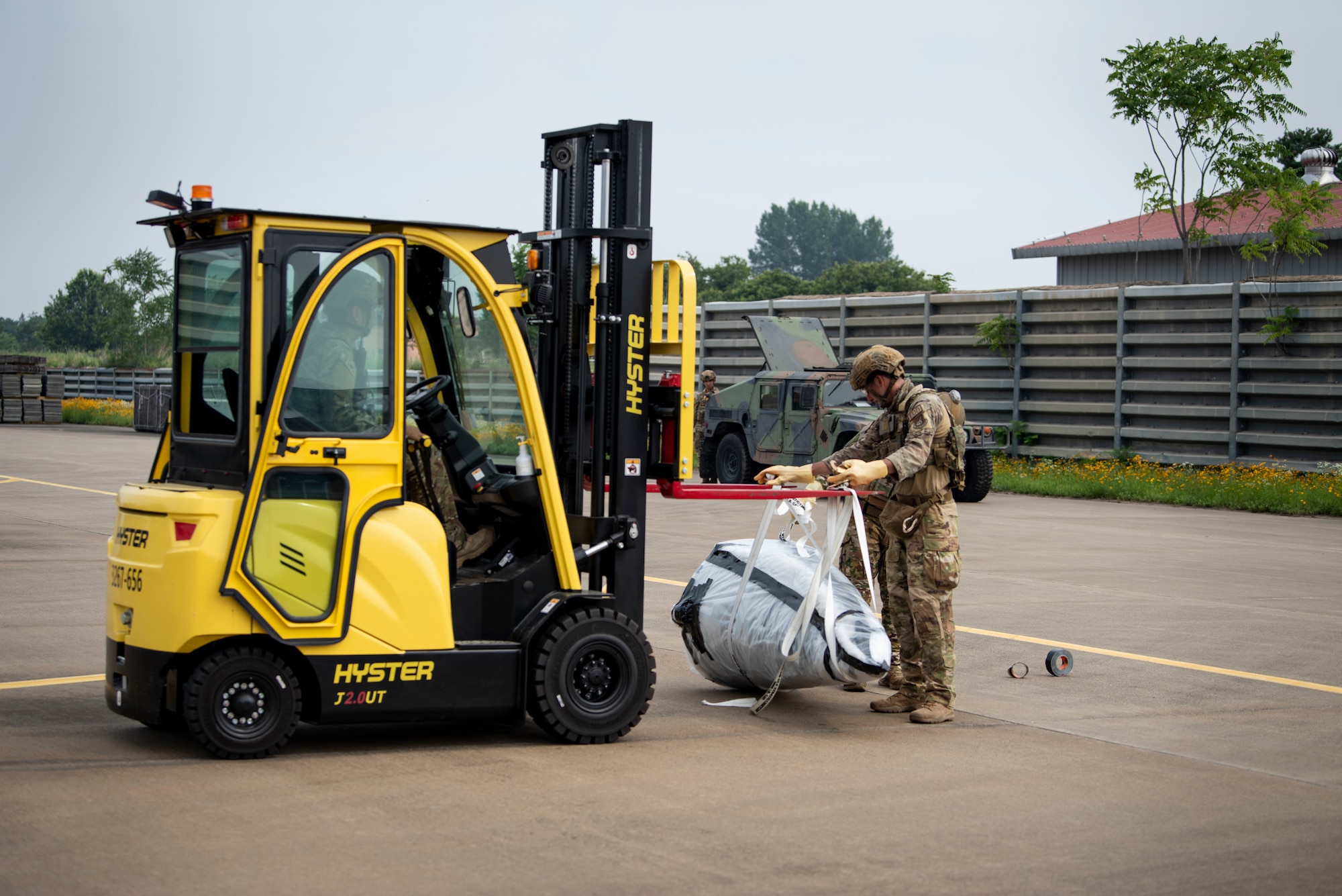 Members of the 35th Civil Engineer Squadron, Explosive Ordnance Disposal flight, assigned to Misawa Air Base, Japan, prepare to transport a mock chemical weapon during a bilateral training scenario at Suwon Air Base, Republic of Korea, July 6, 2022.