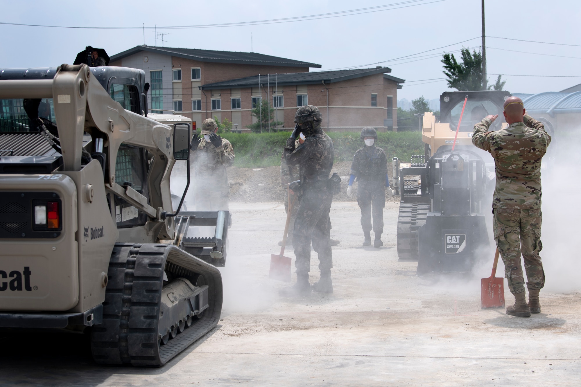 Airman 1st Class Jacob Garrison and Senior Airman Ernesto Silio Cabrera, 35th Civil Engineer Squadron, water and fuels system maintenance technicians from Misawa Air Base, Japan, and members of the Republic of Korea Air Force (ROKAF), practice executing rapid runway repair during a bilateral training scenario at Suwon Air Base, Republic of Korea, July 6, 2022