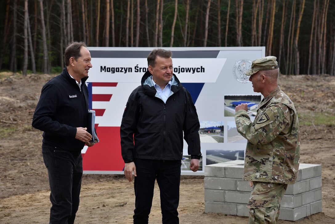 U.S. Ambassador to Poland Mark Brzezinski, Polish Minister of National Defense Mariusz Błaszczak and Poland Provided Infrastructure Program Manager U.S. Army Col. Eric McFadden speak following the groundbreaking ceremony for the Munitions Storage Area being constructed in Powidz, Poland June 2, 2022.  The ceremony marked the beginning of the Poland Provided Infrastructure program, which provides a mechanism for sharing the costs for U.S. forces in Poland. Infrastructure projects are funded by Poland and are designed and constructed to meet U.S. requirements for use by U.S. forces operating in Poland. For its part, the U.S. will continue to bear the costs of training, equipping, deploying and employment of U.S. forces in the country. (U.S. Army photo by Chris Gardner)