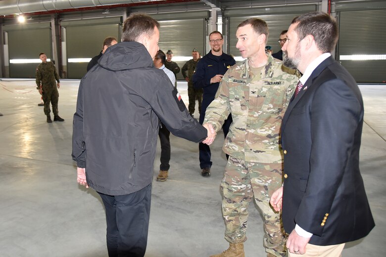 Polish Minister of National Defense Mariusz Błaszczak and U.S .Army Corps of Engineers, Europe District Commander Col. Pat Dagon discuss ongoing military construction efforts in Poland following during a site visit to ongoing Army Prepositioned Stock construction efforts managed by the U.S. Army Corps of Engineers in Powidz, Poland June 2, 2022. The site visit took place following a groundbreaking ceremony for the Munitions Storage Area being constructed nearby. The ceremony marked the beginning of the Poland Provided Infrastructure program, which provides a mechanism for sharing the costs for U.S. forces in Poland. Infrastructure projects are funded by Poland and are designed and constructed to meet U.S. requirements for use by U.S. forces operating in Poland. For its part, the U.S. will continue to bear the costs of training, equipping, deploying and employment of U.S. forces in the country. (U.S. Army photo by Chris Gardner)