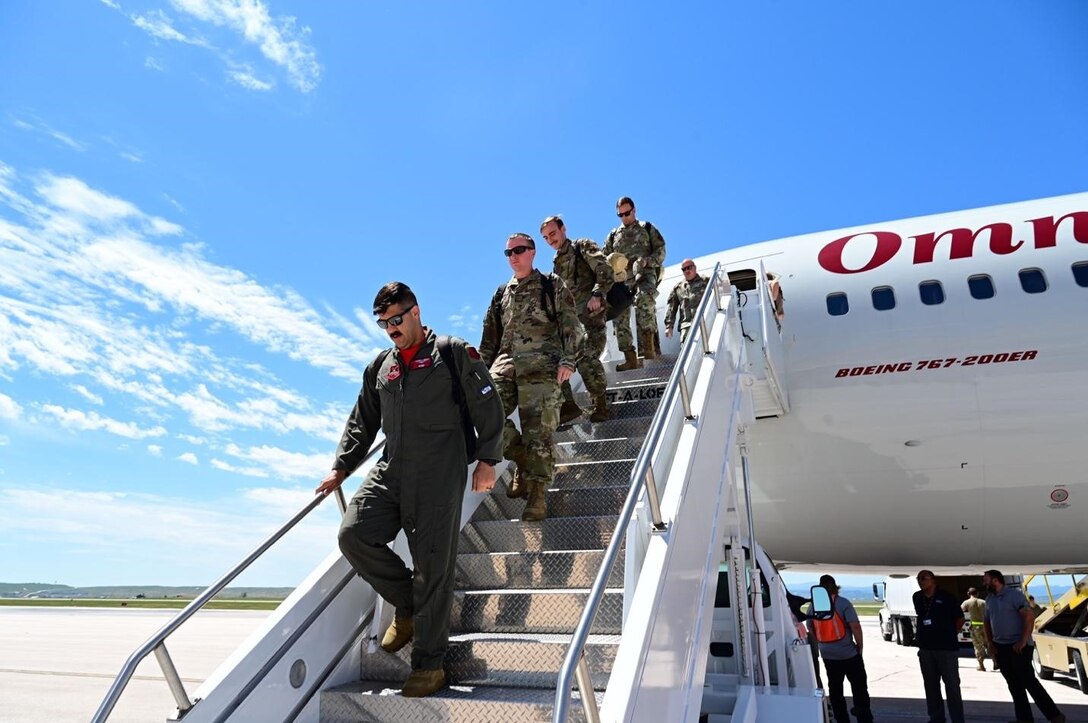 Airmen, assigned to 28th Bomb Wing, exit a Boeing 767 at Ellsworth Air Force Base, South Dakota, after returning from a Bomber Task Force Mission, July 4.