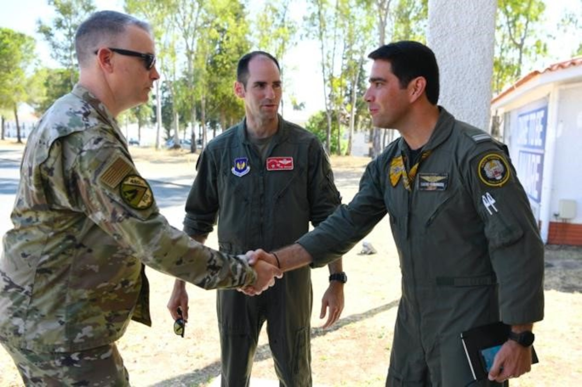 U.S. Air Force Col. Thomas Graham, 52nd Operations Group commander (center), and Chief Master Sgt. Mark Rogers, 52nd Operations Group senior enlisted leader (left), both  stationed at Spangdahlem Air Base, Germany, greet Maj. Jose “Driller” Fernandes of the Portuguese air force, during a key leader engagement at Exercise Real Thaw 22, on Beja Air Base, Portugal, July 5, 2022. Senior leadership from participating NATO partner countries visited in order to observe this significant European exercise. (U.S. Air Force photo by Tech. Sgt. Warren D. Spearman Jr.)