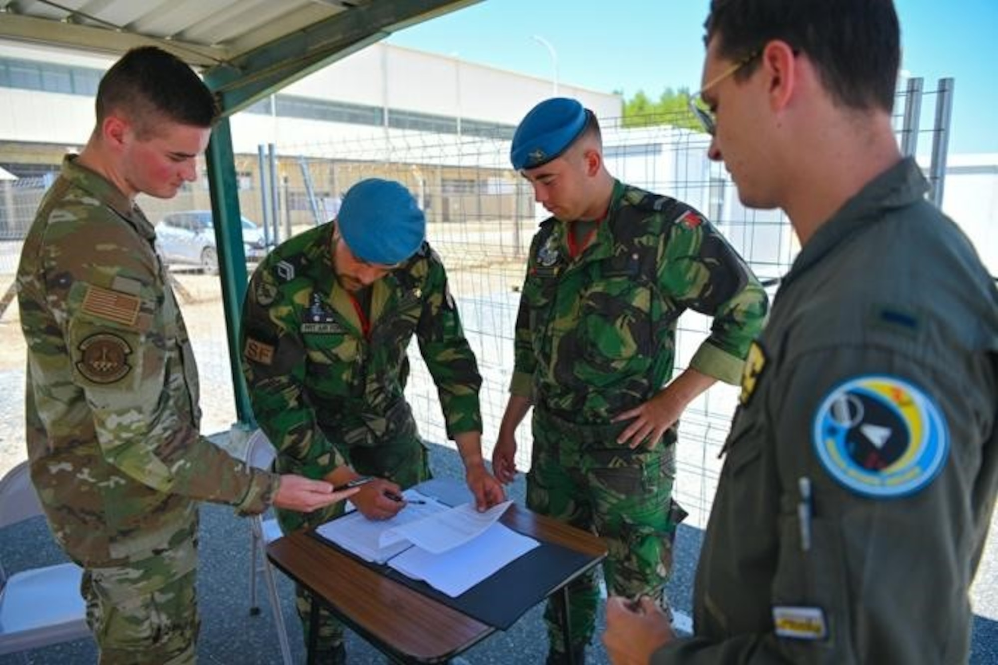 U.S. Air Force Airman 1st Class Stone Miller, 52nd Security Forces Squadron patrolman (left), stationed at Spangdahlem Air Base, Germany, works with air police from the Portuguese air force to check the entrance clearances at Exercise Real Thaw 22 on Beja Air Base, Portugal, July 6, 2022. Working alongside Allies allows our forces the capability to adapt to today’s complex security environment and ensures the defensive power of NATO remains unmatched. (U.S. Air Force photo by Tech. Sgt. Warren D. Spearman Jr.)