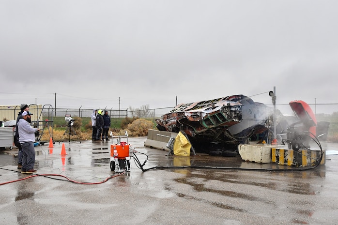 A salvaged F-35A is cut in half with the volunteer help of a civilian saw manufacturing company March 31, 2022, at Hill Air Force Base, Utah. The aircraft was condemned after an accident and is currently being transformed into sectional training aids by the 372nd Training Squadron, Det. 3, for use during instruction of F-35 maintainers. (U.S. Air Force photo by Todd Cromar)