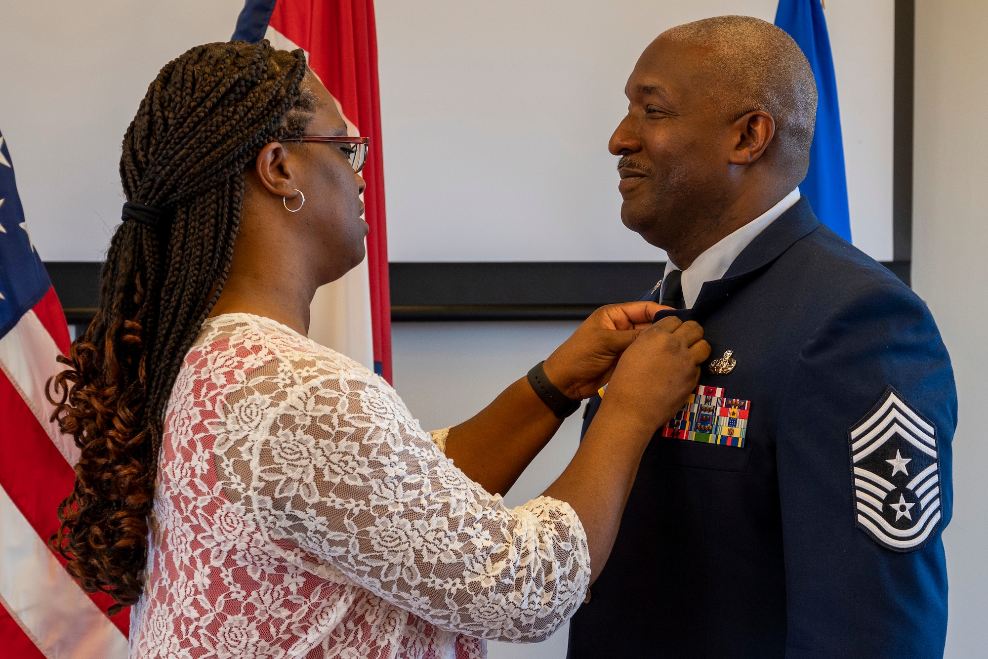 Chief Master Sgt. LeRoy E. McCardell Jr., 131st Bomb Wing command chief master sergeant, is pinned by his wife during his retirement ceremony, June 25, 2022, at Jefferson Barracks Air National Guard Base, St. Louis, Missouri. McCardell served for 34 years. (U.S. Air National Guard photo by Senior Airman Whitney Erhart)